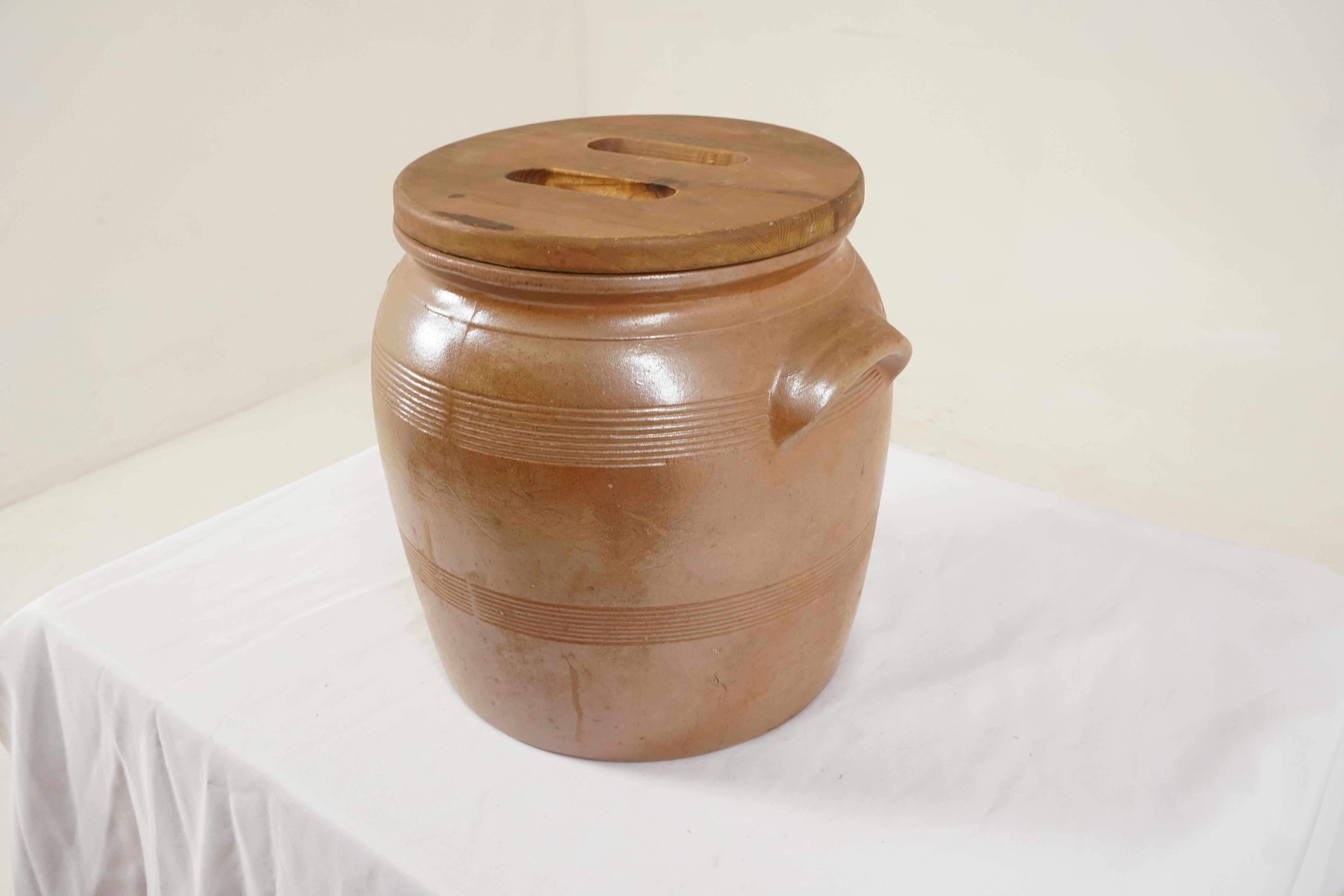 Antique large Scottish Earthenware crock, pickling barrel, Pine Lid, Scotland 1920, B1747y

Scotland 1920
Circular in shape
Pine lid with cut-outs to the top
The barrel has lifting handles to the sides
Rings around the top and near the