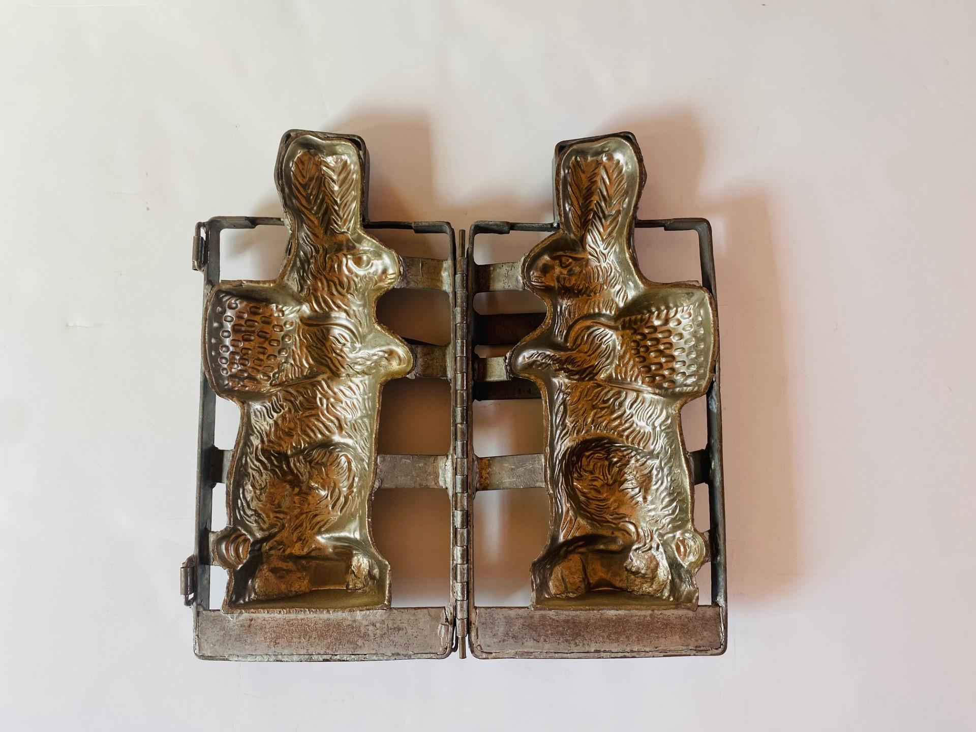 Incredibly dense cast aluminum two-part chocolate mold, in the form of a standing Easter bunny with a woven basket on his back.  Incredible antique piece that is timeless.  The piece is full of detail and its quality withstands time. This piece was