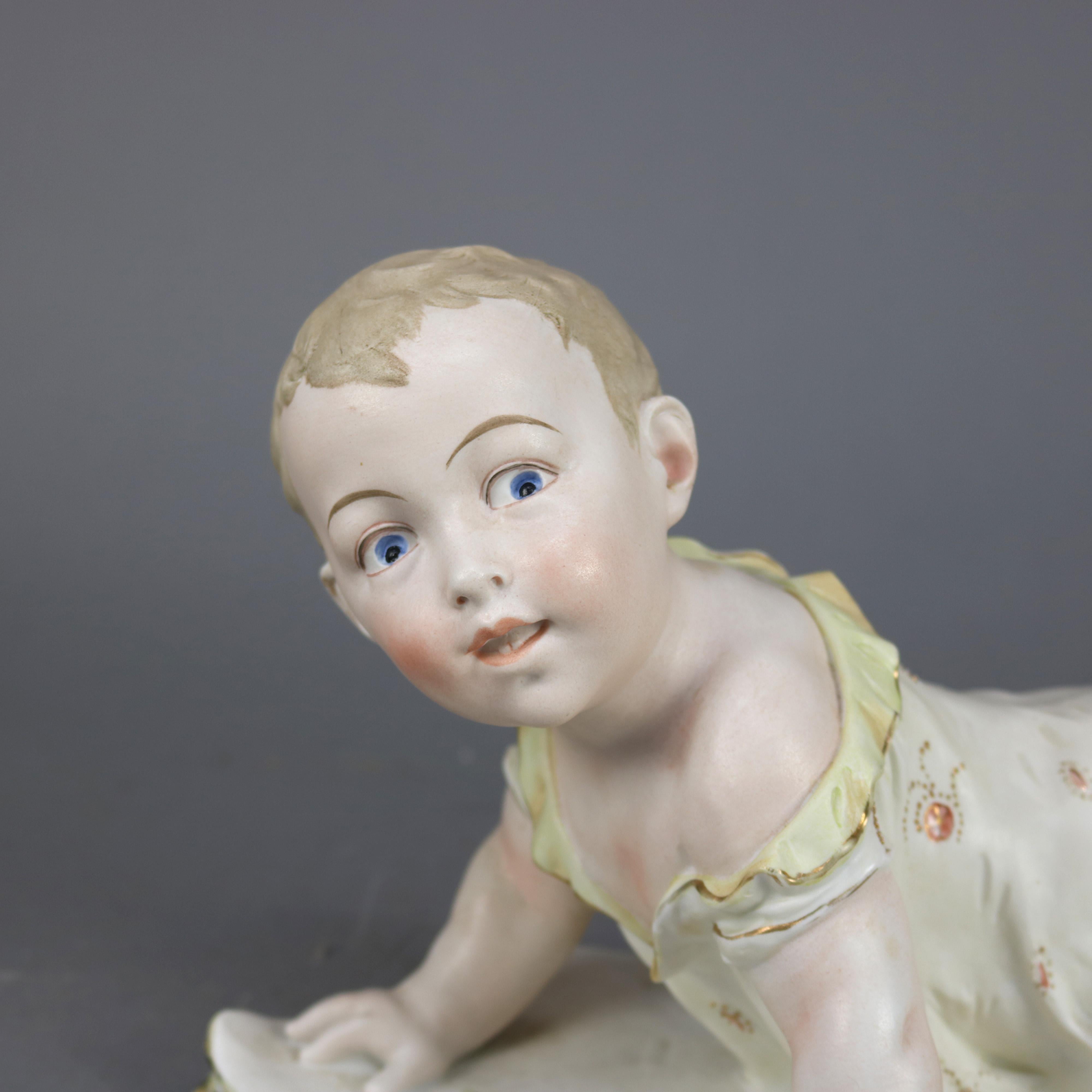 An antique large English bisque porcelain piano baby offers hand painted and gilt baby on blanket or book, circa 1890.

Measures: 8.5