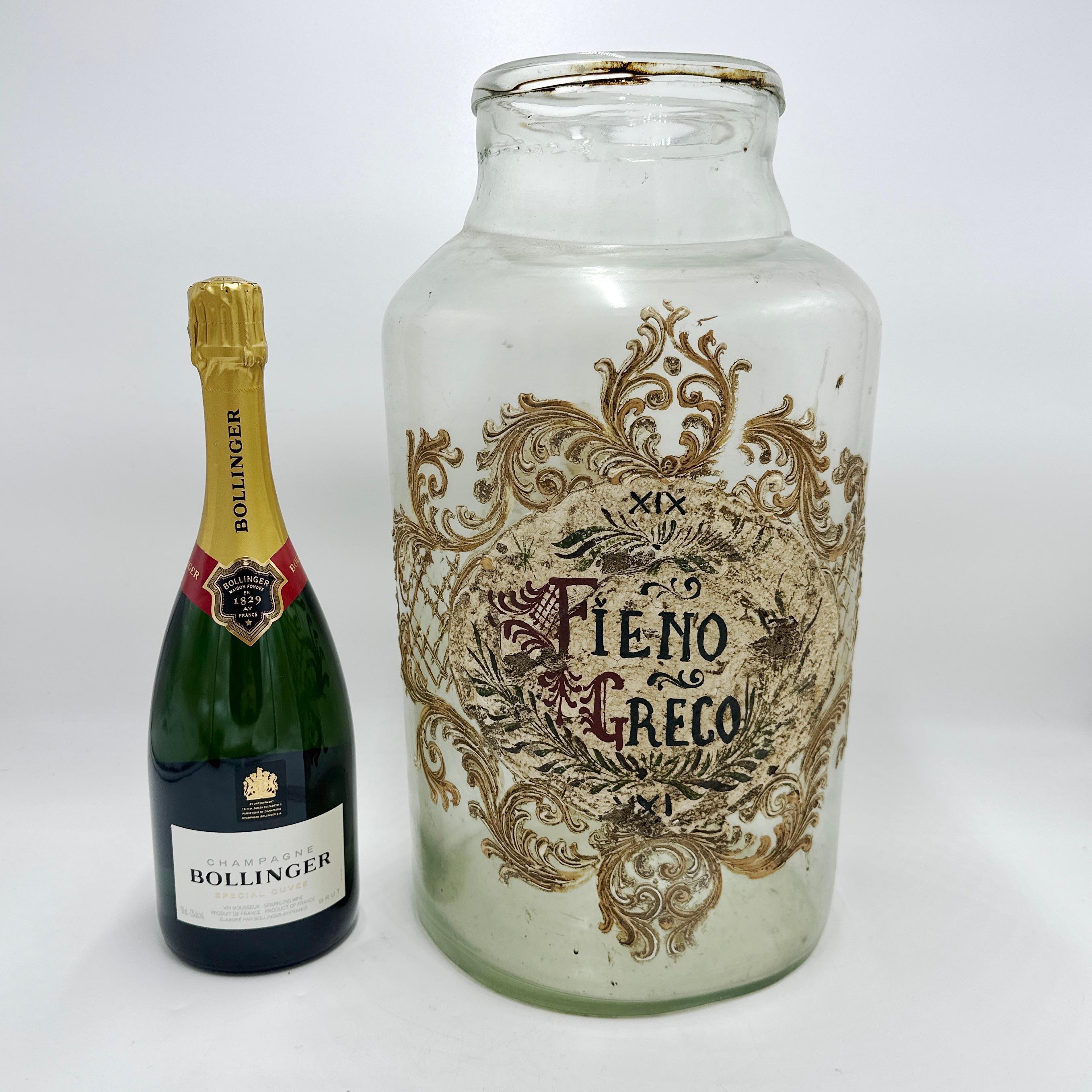 Here is a beautiful Antique and Large Italian Murano Glass Pharmacy Apothecary Jar. Elaborately hand painted and gilt on a clear Murano glass. Reads “FIENO GRECO” on the label which translates from Italian into Fenugreek

Some loss to paint and wear