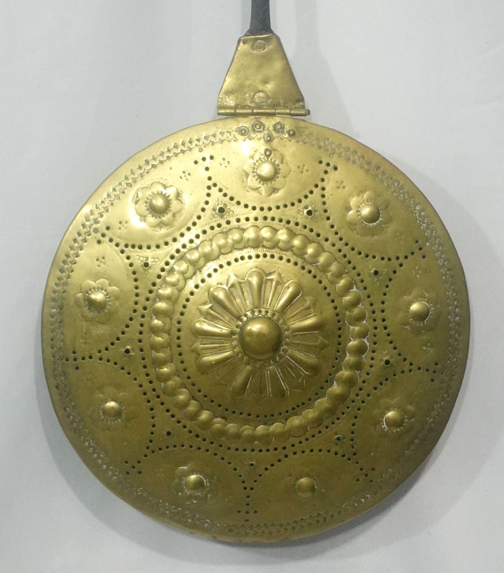 French, brass bedwarmer with iron handle, delicate pattern design in punched and hand-hammered design from the 18th century. European warmers have metal handles.

They were heated by stones put inside to provide a transfer of heat. They stay hot and