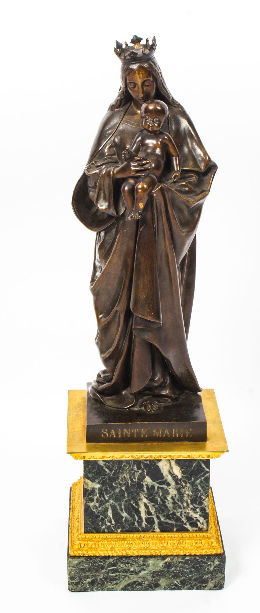 This is a large finely cast brown patinated bronze ormolu and marble sculpture of Sainte Marie by De Beaumont. It is signed on the base and also inscribed 