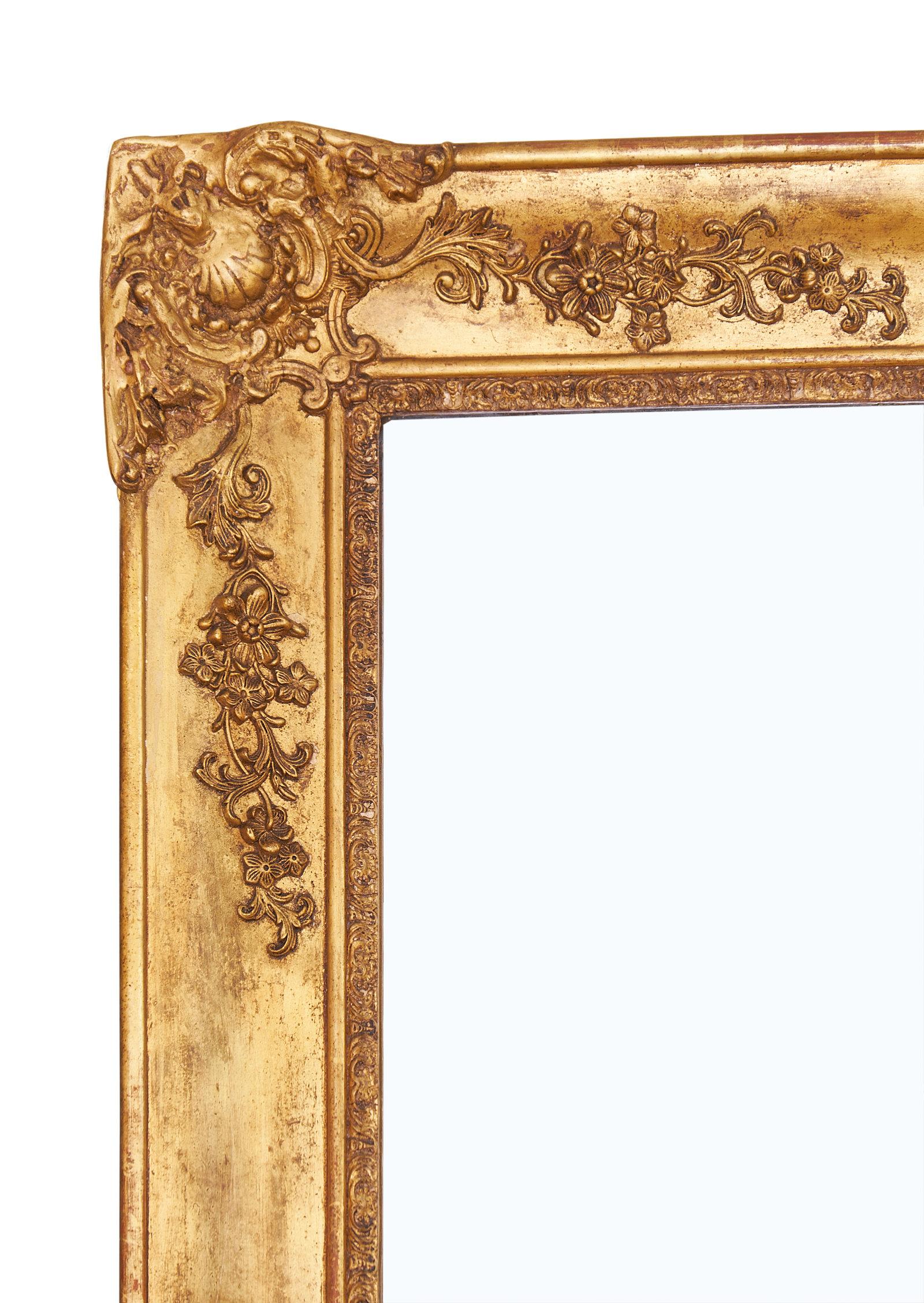 A spectacular large French antique mirror featuring an ornate frame with hand carved godrons and florals. The original mercury mirror is intact. We love the impressive size and quality of this piece!