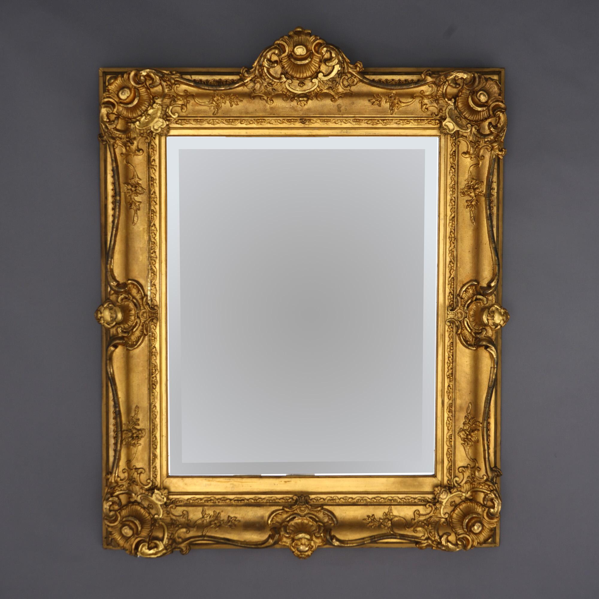 An antique and large French Renaissance wall mirror offers a giltwood frame with shell and foliate elements, beveled mirror, 19th century

Measures - 47.5