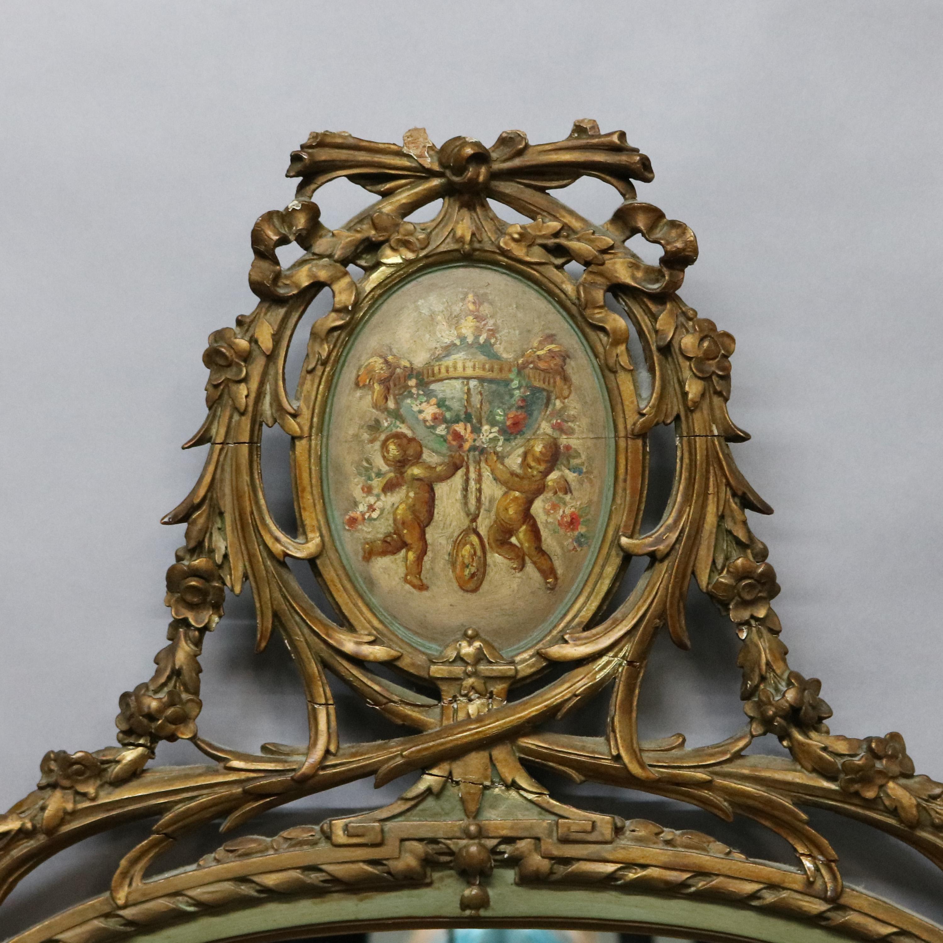 An antique French style wall mirror offers giltwood frame with foliate reticulated crest having central Adam decorated medallion having Classical cherub scene and twisted ribbon trim, mirror has etched panels with rosettes, c1920.

Measures: