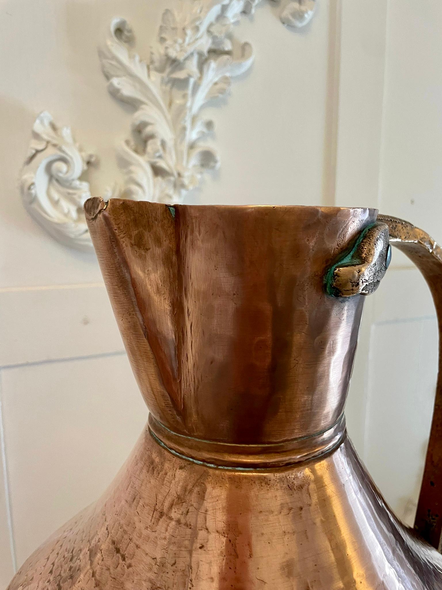 Antique large George III quality copper water jug Having a quality antique George III large shaped water jug with the original brass shaped handle 

The pictures show it with a smaller example which is for sale separately

H 45 x W 33.5 x