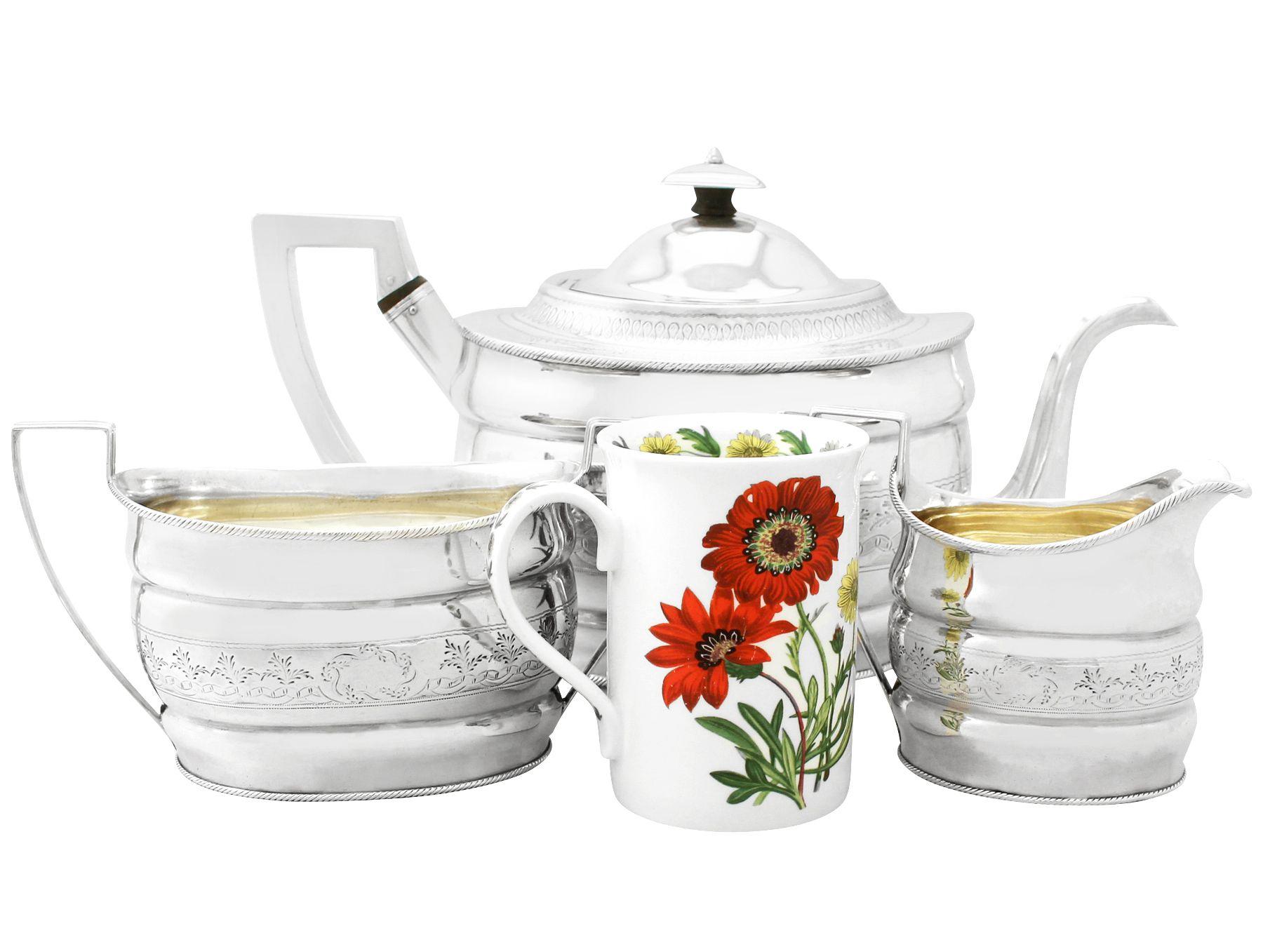 A fine and impressive, large antique Georgian English sterling silver three-piece tea service/set; part of our silver teaware collection.

This fine antique George III sterling silver three piece tea service consists of a teapot, cream jug and