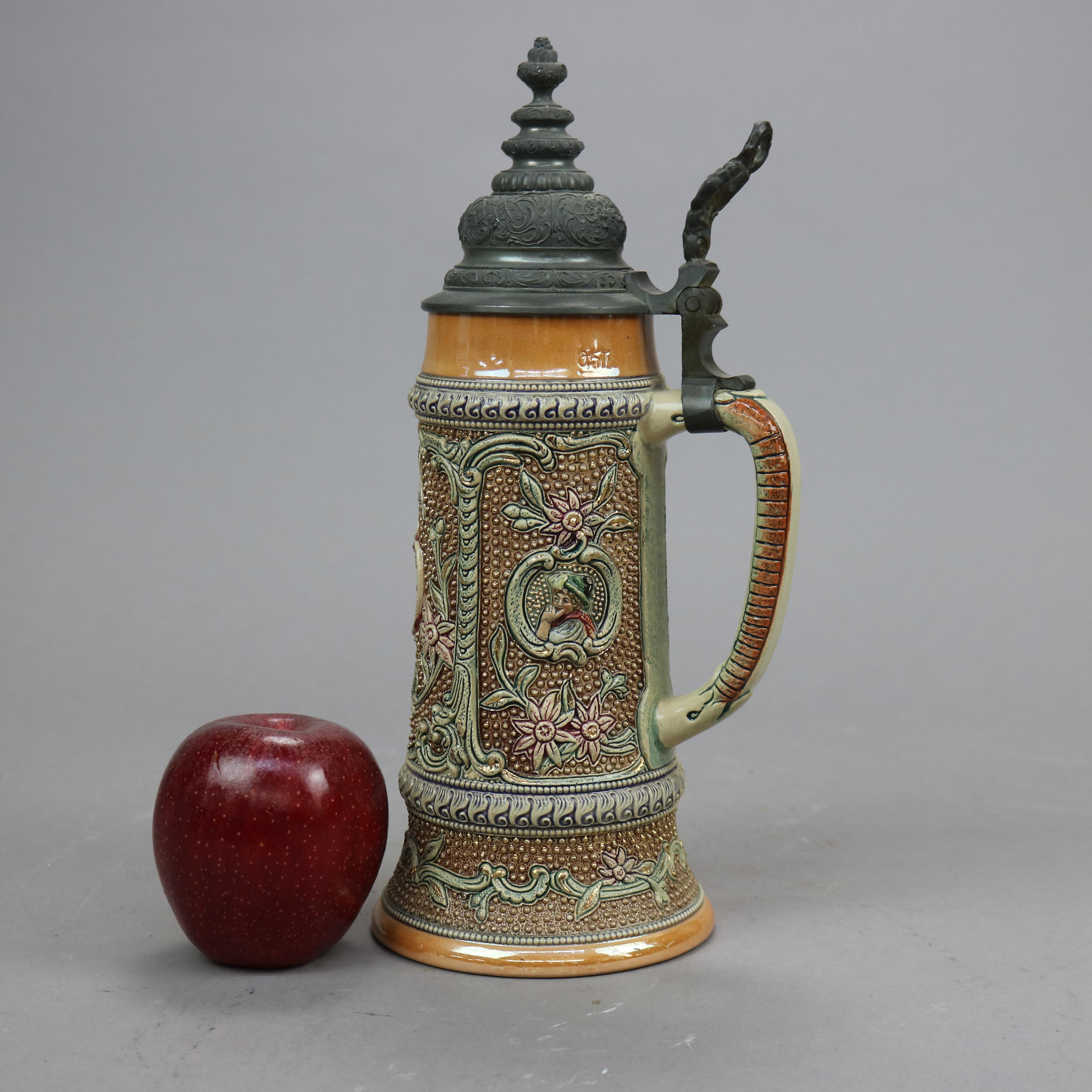 An antique and large German beer stein offers stoneware construction with reserves having figural portraits, flowers and foliate elements in relief, hinged pewter lid, c1900

Measures- 11.5'' H x 4.25'' W x 5.5'' D.

Catalogue Note: Ask about