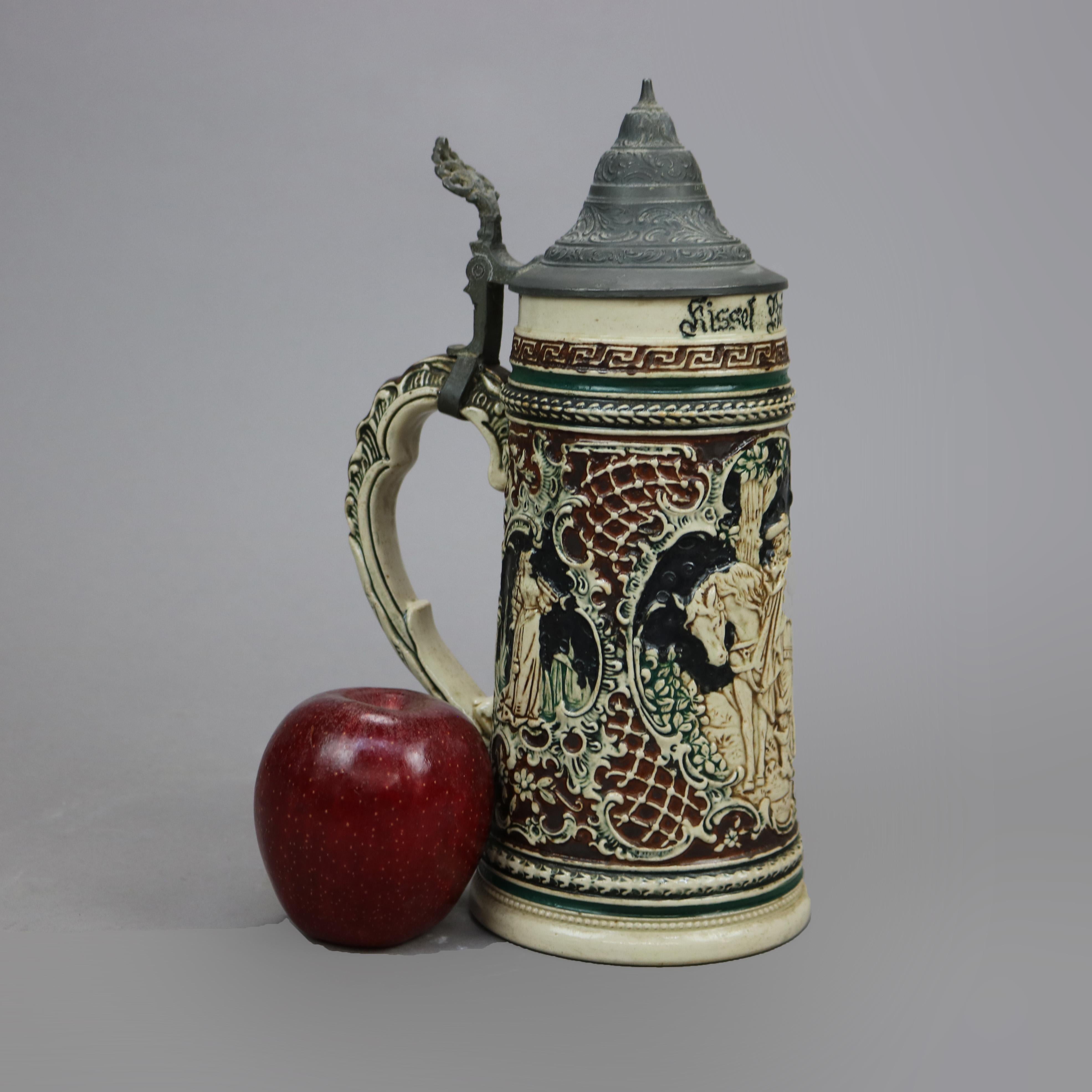 An antique and large German beer stein offers stoneware construction with reserves having figures, horns and a horse in relief, hinged pewter lid and stamped as photographed, c1900

Measures- 10.75'' H x 4.25'' W x 6.25'' D.

Catalogue Note: Ask