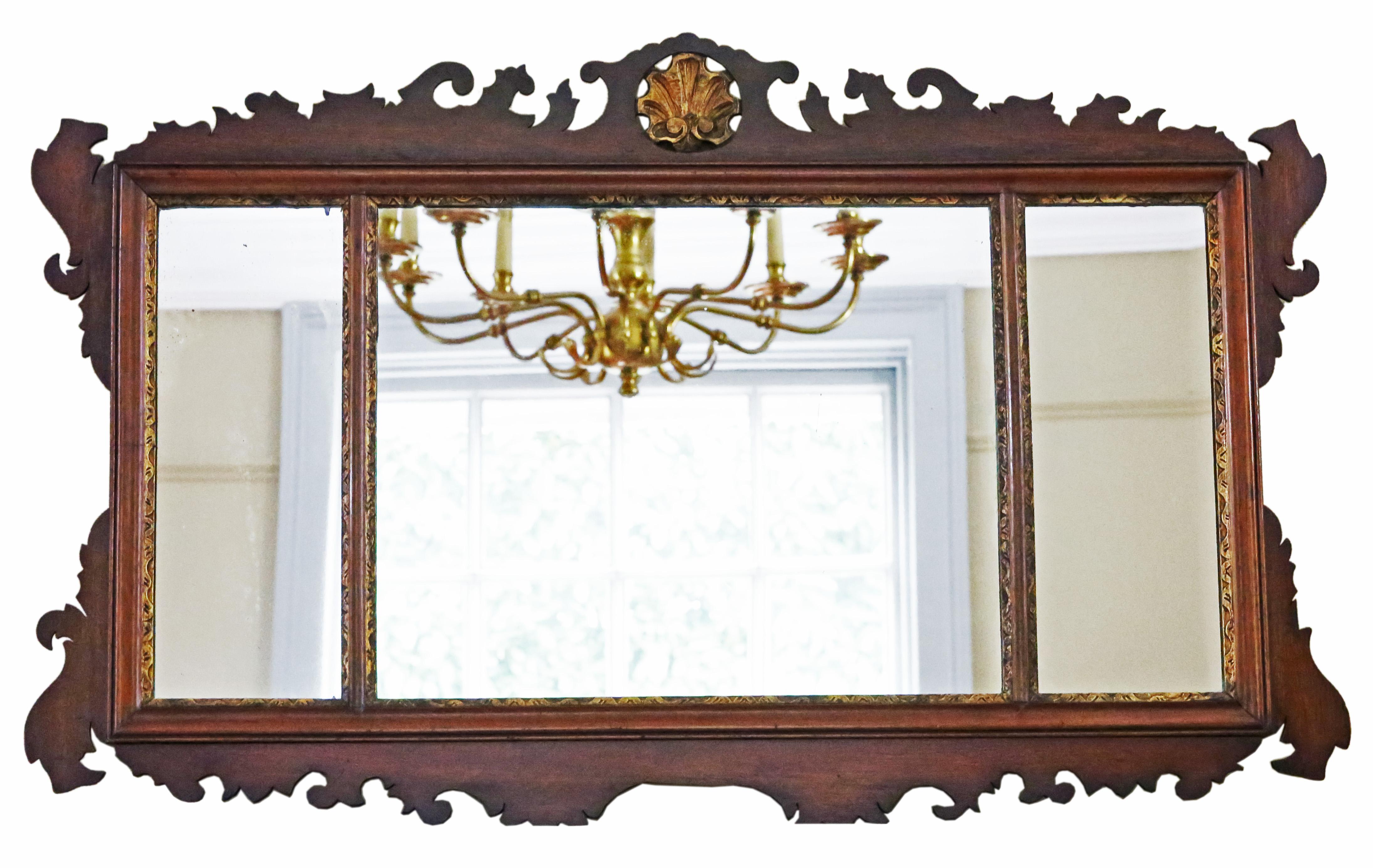Antique large gilt and mahogany overmantle wall mirror from circa 1900, featuring fine quality and adorned with a decorative fret-cut design.

This mirror captivates with its simple yet striking design, enhancing the character of any suitable space.