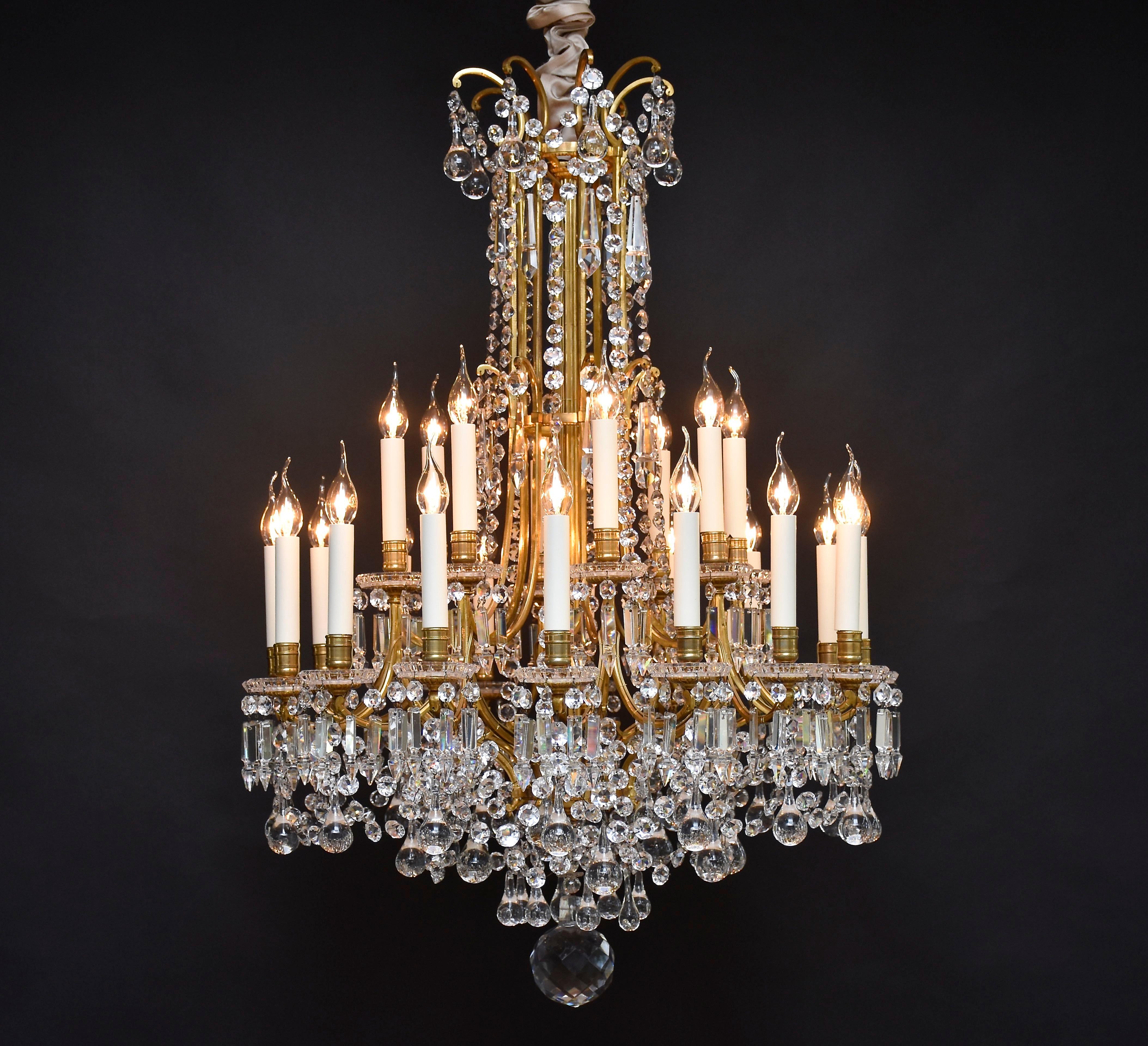 An outstanding large gilt bronze Baccarat chandelier with 24 lights from the prestigious and famous French crystal manufacturer- Baccarat. 
Richly decorated with delightful string of cut octagons and drops that capture beautifully the light.
Place