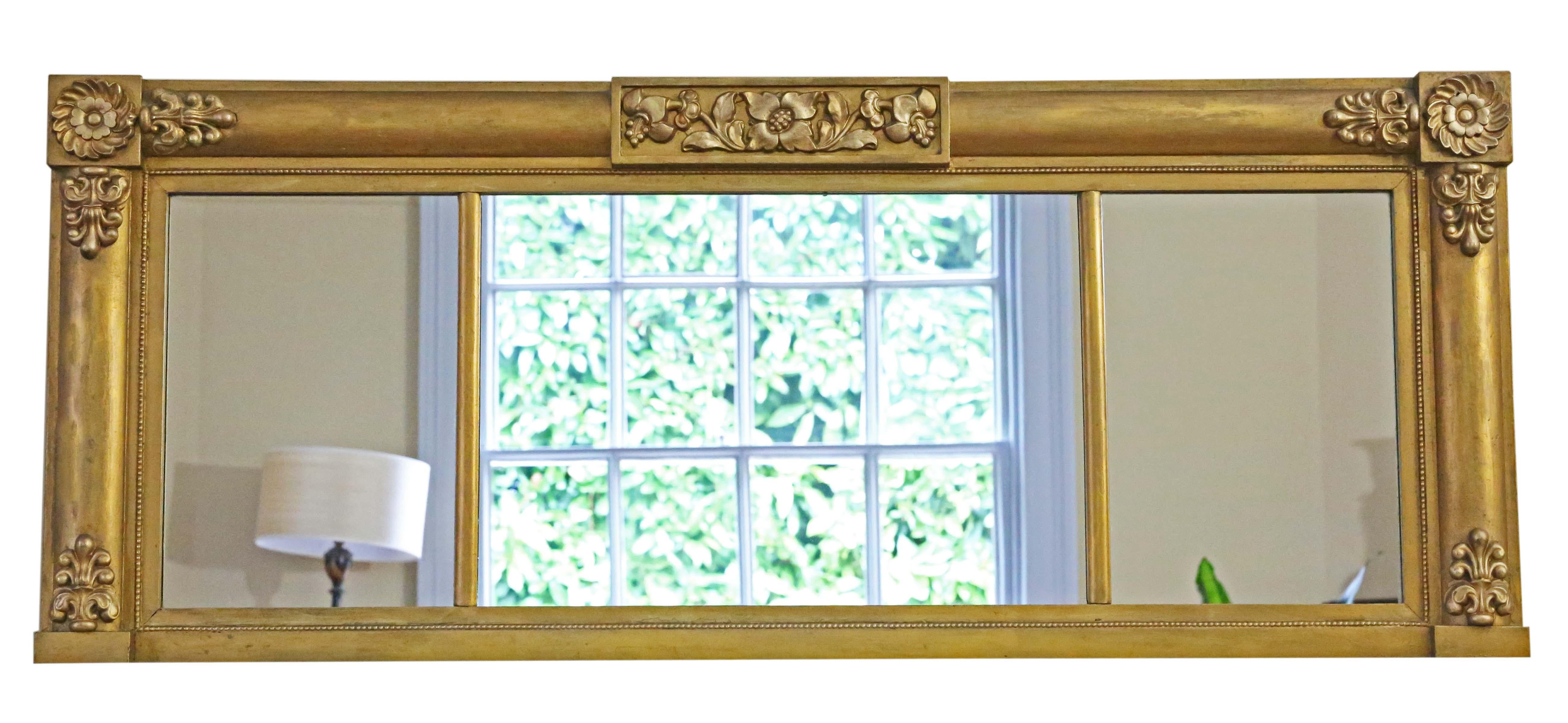 Antique large gilt overmantle wall mirror from the 19th Century, boasting fine quality with delicate floral decoration.

This mirror captivates with its simple yet striking design, adding character to any suitable space. The frame is robust, free
