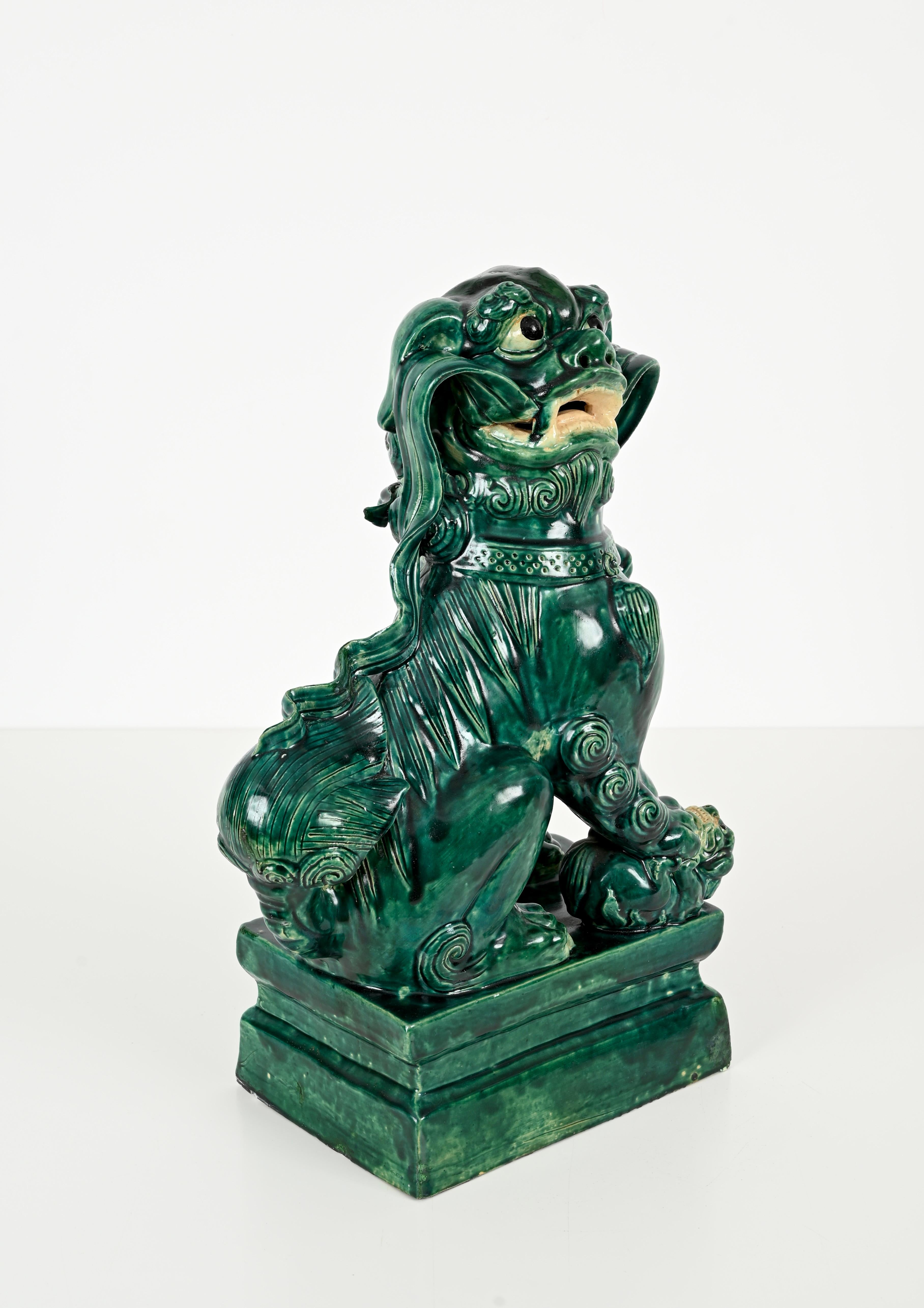 Marvelous antique foo lion dog sculpture in green glazed ceramic. This outstanding object was hand-made in the early 1900s.

This fine quality ceramic sculpture has outstanding details such as the sinuous whiskers or the collar that give a sense of