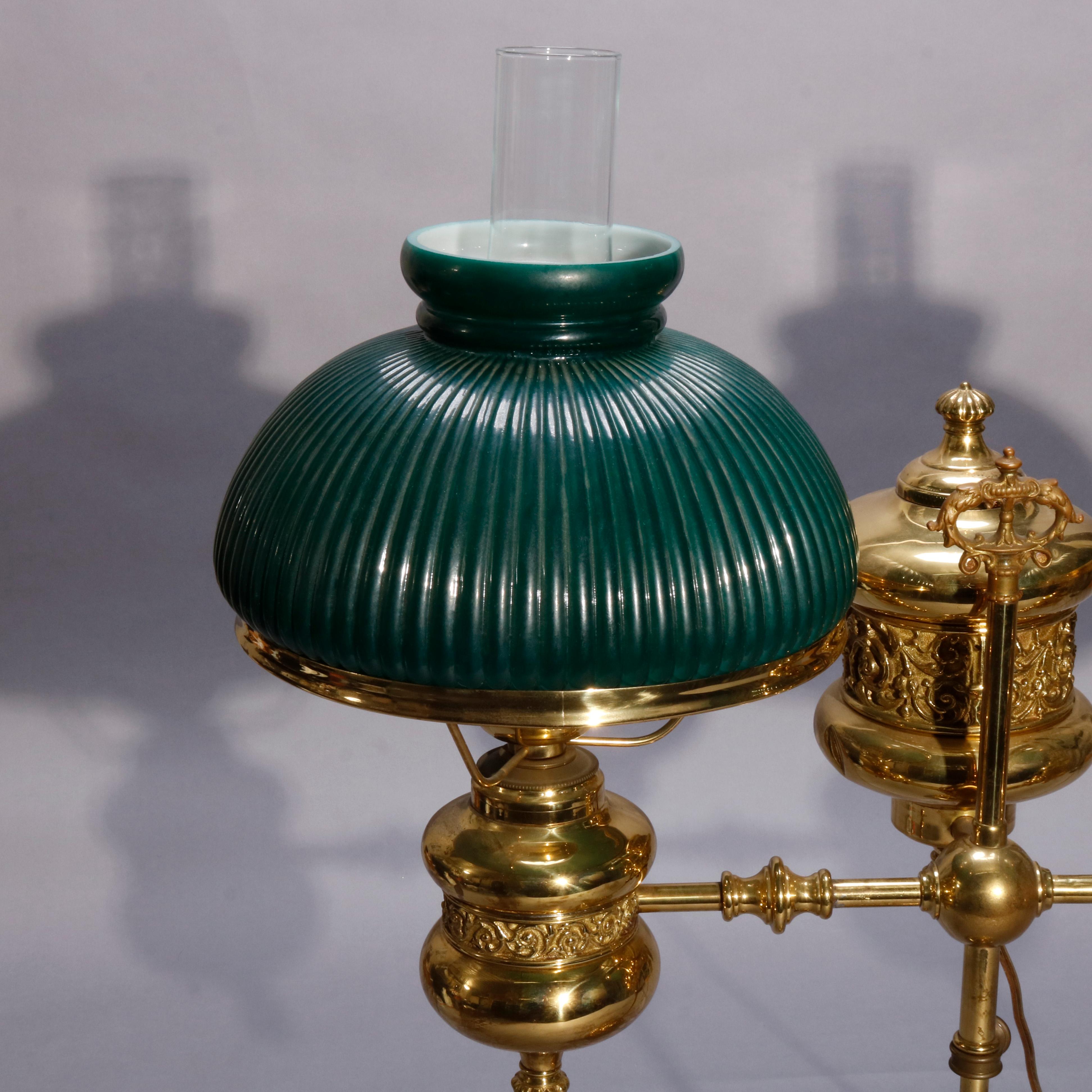 Une ancienne et grande lampe d'étudiant double électrifiée de l'école de Harvard offre une base en laiton avec une fonte embossée de feuillages et de volutes:: des bras doubles réglables se terminant par des lumières avec des abat-jour en verre