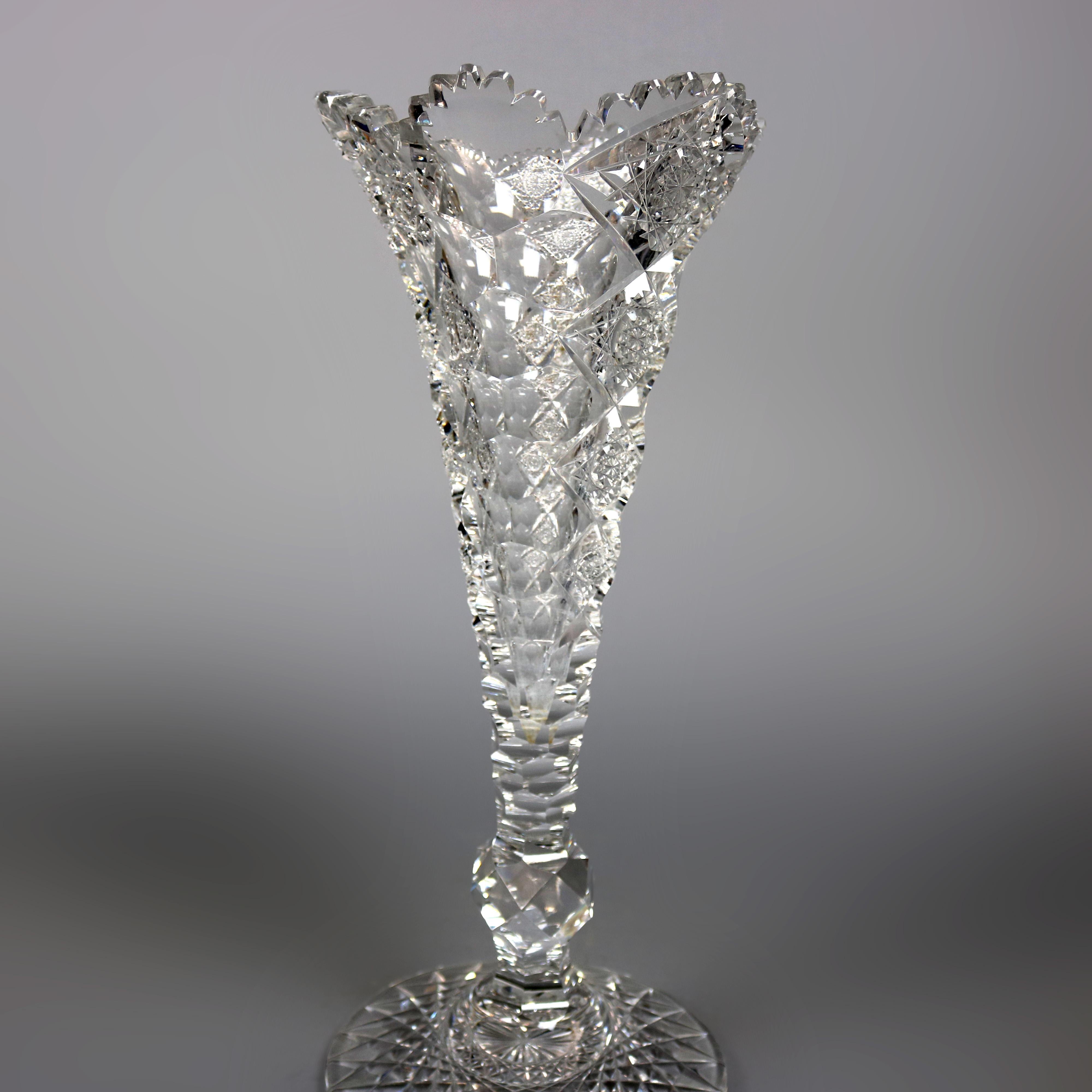 An antique and large cut glass vase by Hawkes offers footed trumpet form in Queens Pattern, circa 1900

Measures: 15.13