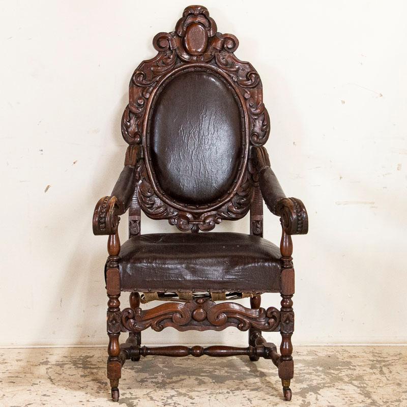 Loaded with character, this heavily carved armchair has tremendous appeal thanks to the aged leather that compliments the extensive hand-carving. While the chair shows extensive use, such as the underside of the seat and back, the leather will