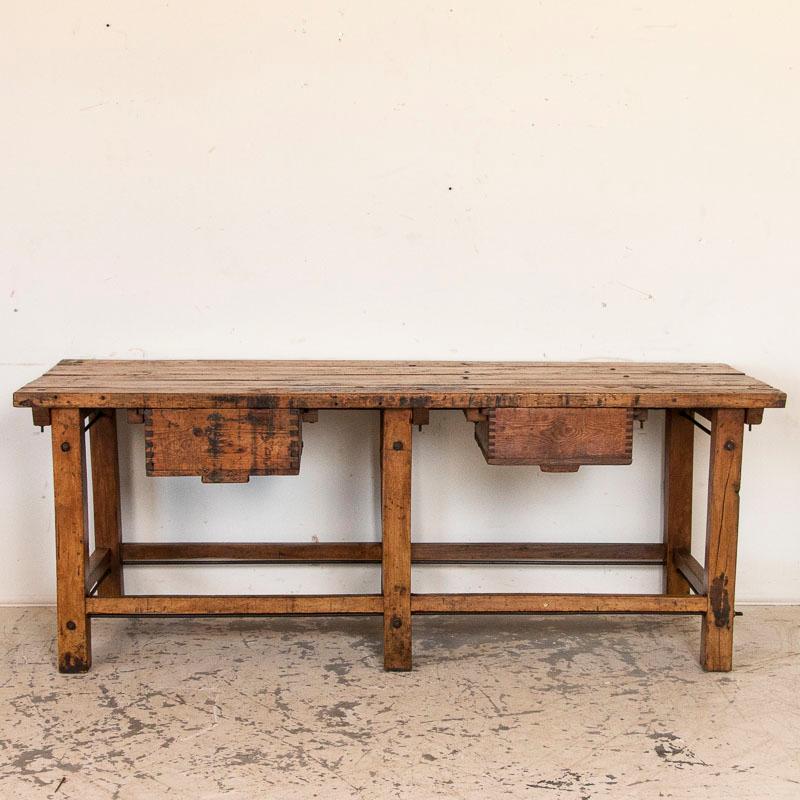 Loaded with character, the rich, deep patina of this old Swedish work table is due to the years of use reflected in every scrape, stain, ding and crack. The two deep drawers slide out from the front (no pulls). Notice how the base is reinforced with