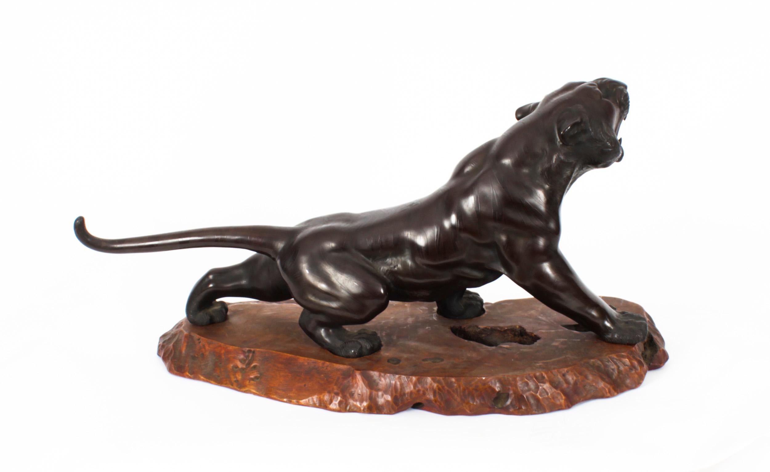A beautiful large Japanese patinated bronze study of a crouching tiger, signed on the belly, Genryusai Seiya, Meiji period, 1868-1911 in date.
 
The finely cast sculpture shows a striding figure with its head raised and mouth open to reveal long