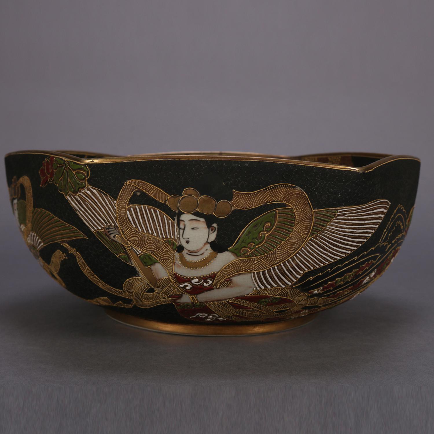 An antique and large Japanese Satsuma bas relief porcelain center bowl features scalloped rim with hand painted and gilt village scene with figures on interior and figures on exterior, chop mark signed on base as photographed, circa