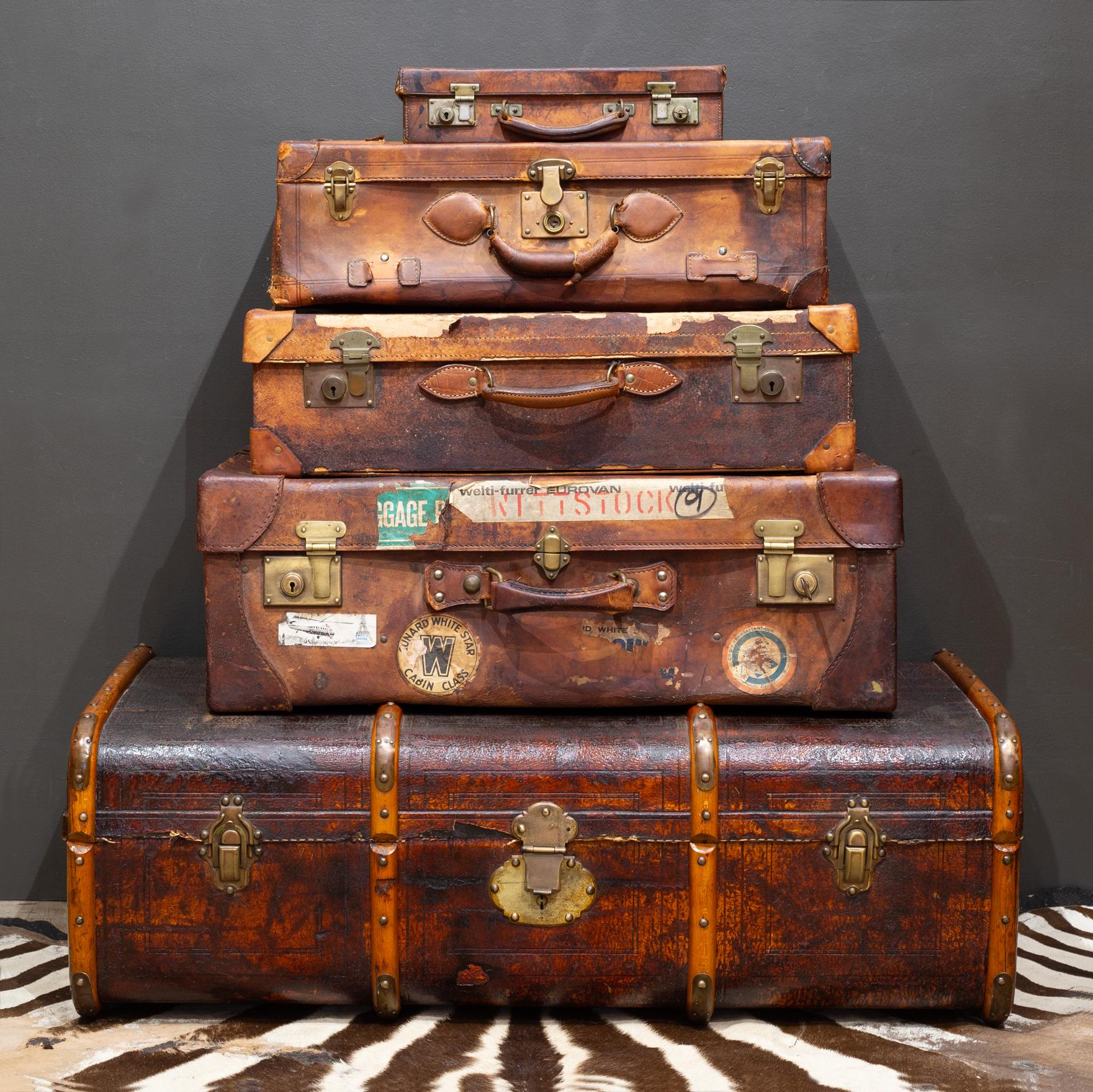 ABOUT

Antique large leather suitcase with fabric interior, interior pouch, leather straps, brass latches and original key and locks. Original travel tag, 