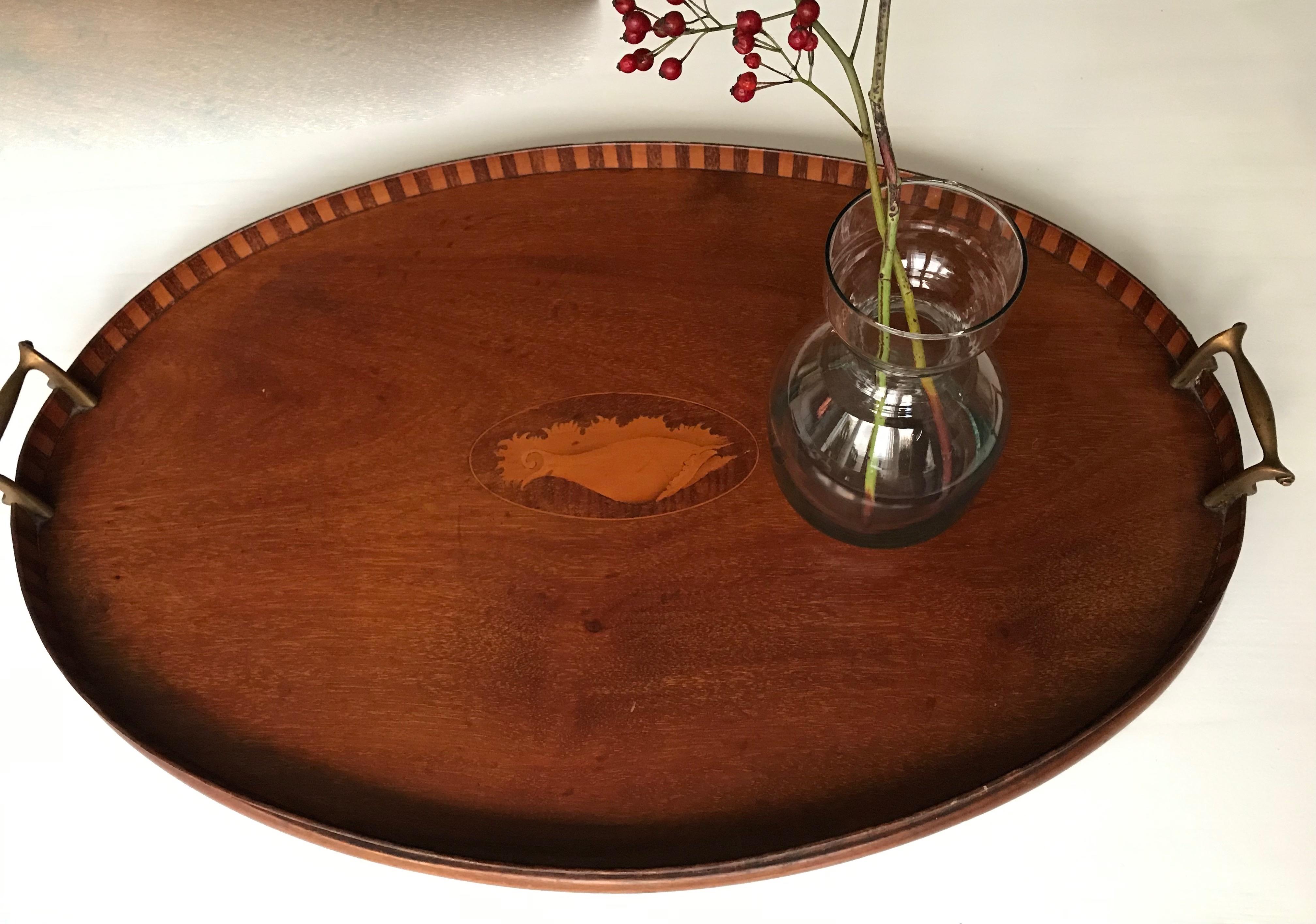 Practical and decorative, large serving tray.

If you are looking for a large, stylish, decorative and good quality antique serving tray then this Fine example could be the one for you. The outside rim is beautifully inlaid with so called intarsia