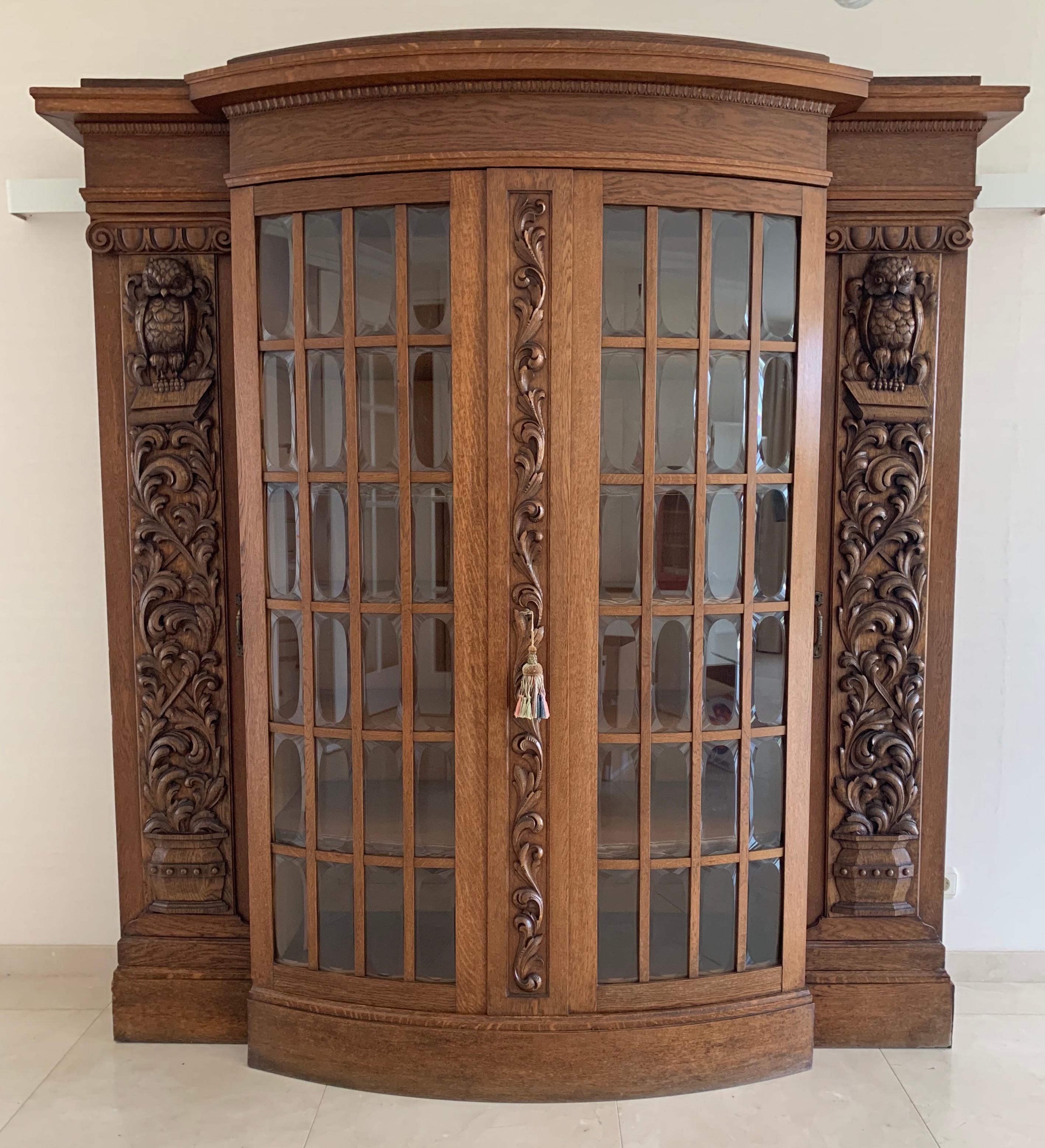 Remarkable design bookcase or cupboard with stunning owl sculptures.

This large size, grand and impressive in appearance cabinet is another great example of the workmanship of some of the better furniture makers in turn-of-the-century Europe.