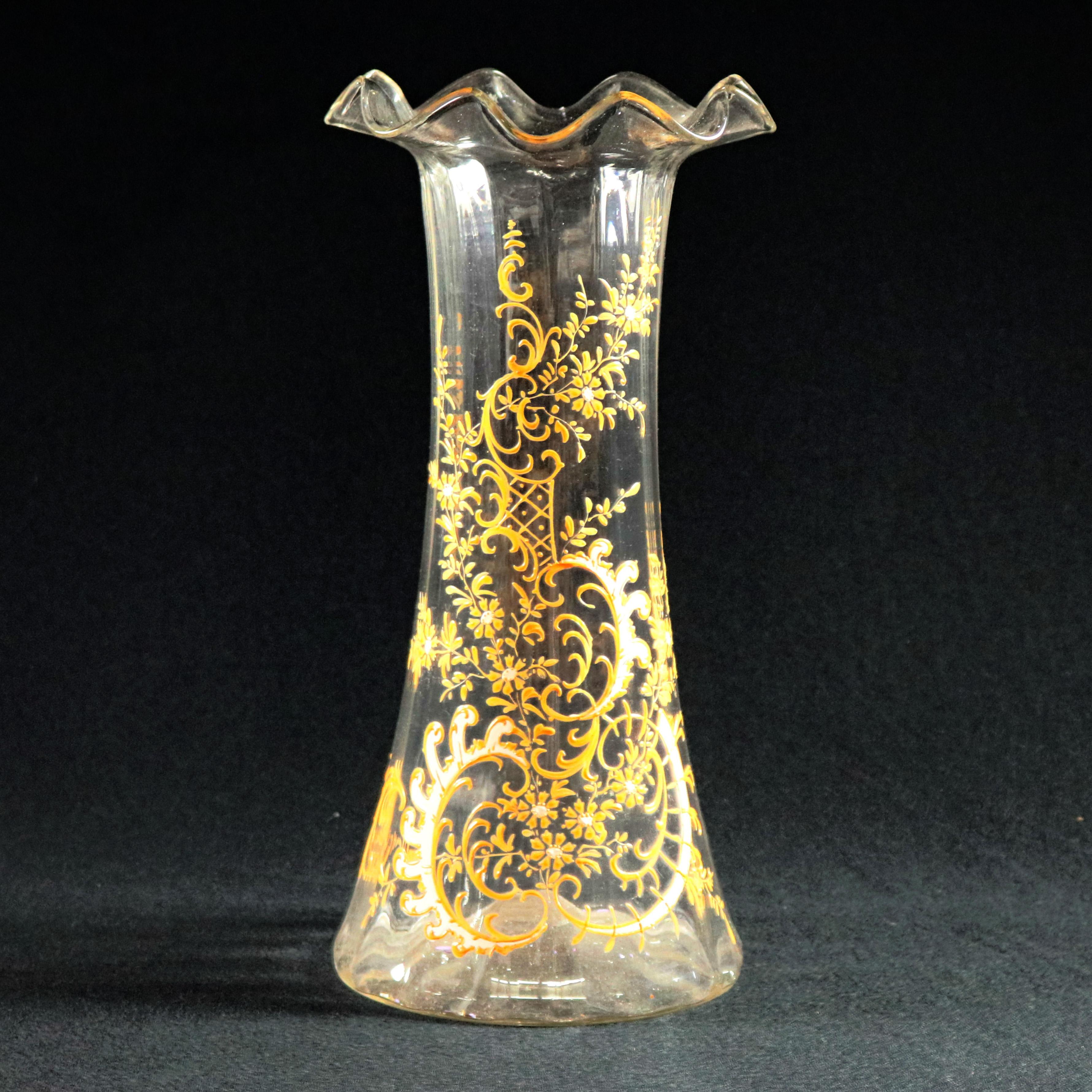 An antique and large Moser School blown glass vase offers ruffled rim surmounting vessel with hand gilt and enameled scroll and foliate decoration, 19th century


Measures: 14.25