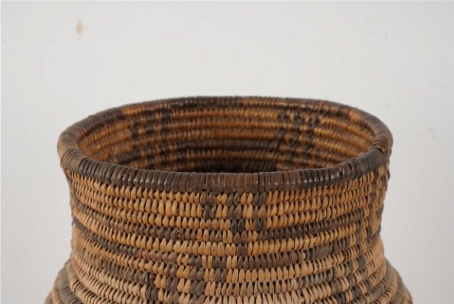 This antique North American Indian Olla is woven of willow and devil's claw with geometric elements. The Apache, a nomadic American Indian tribe, followed the buffalo and ranged across the American Southwest including areas of Arizona, Texas, New