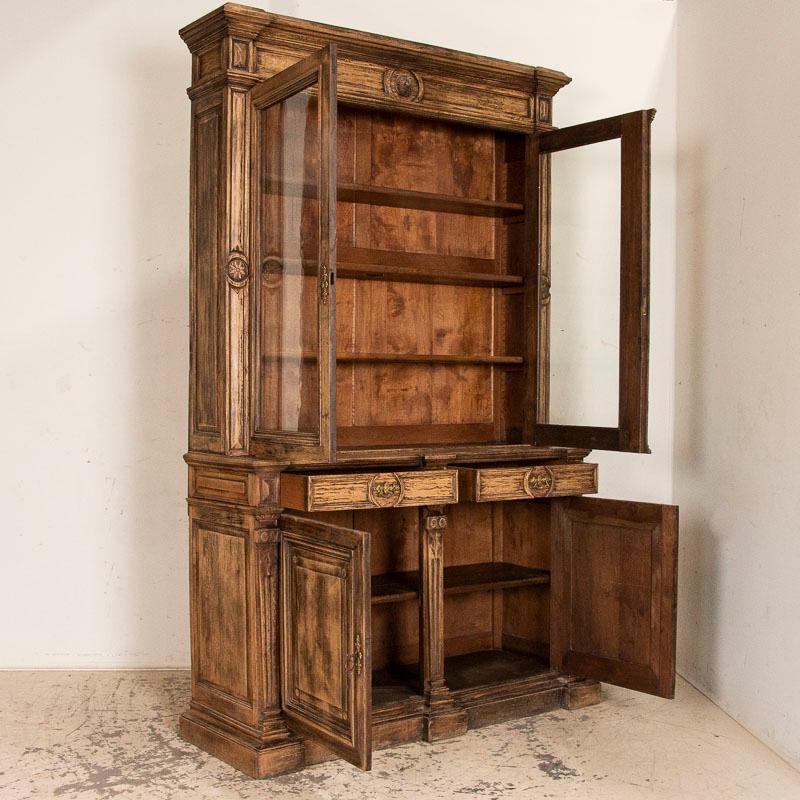 This large oak bookcase is statuesque in size and detail. At over 8' tall, the carved medallion, star, and heavy paneled accents add to its strong presence. Even the sides show off the attractive paneling. Notice in the detailed photos the