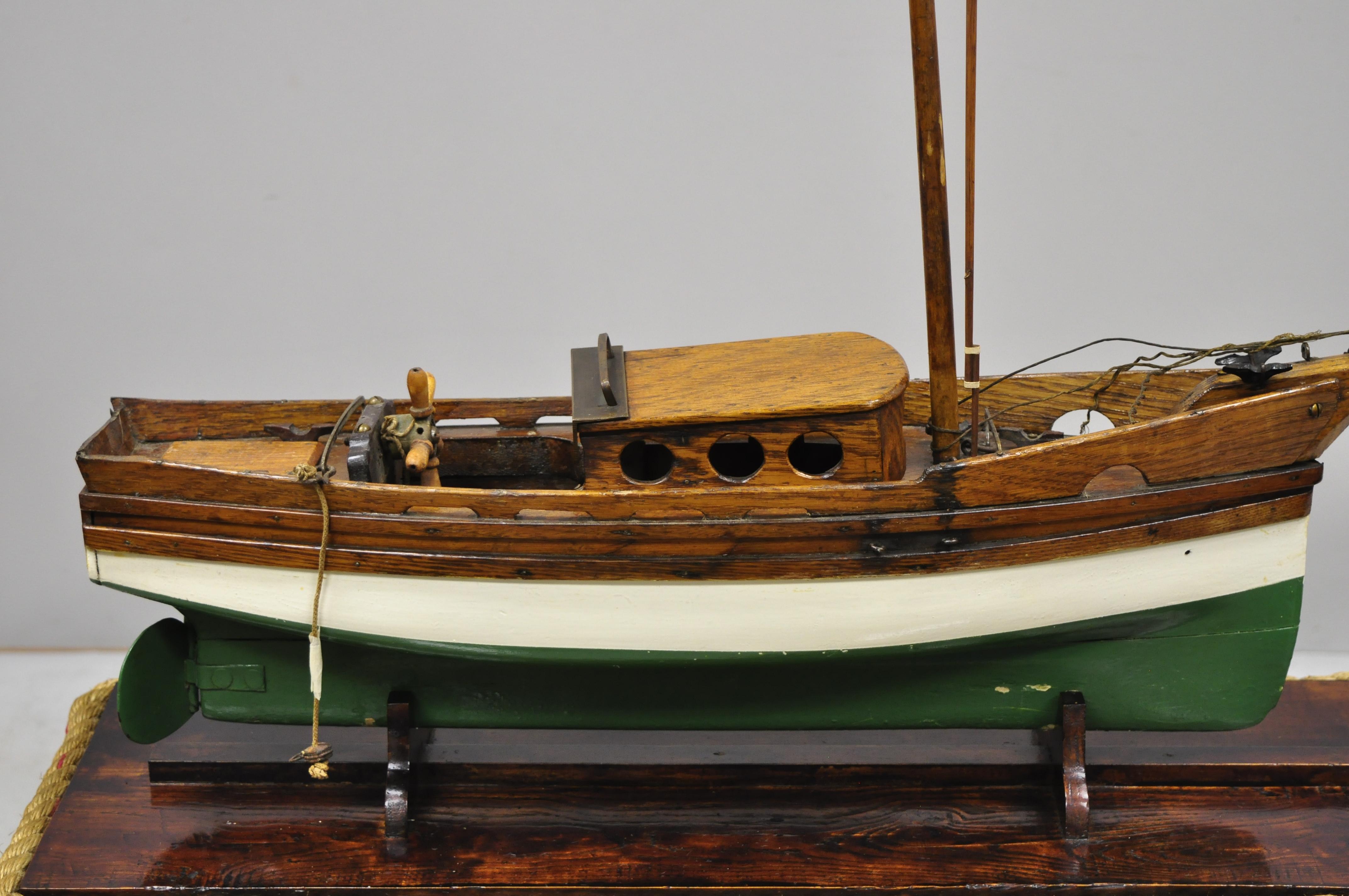 Antique large oakwood model sailboat ship boat on base stand, circa early to mid-20th century.
Measurements: On stand: 26