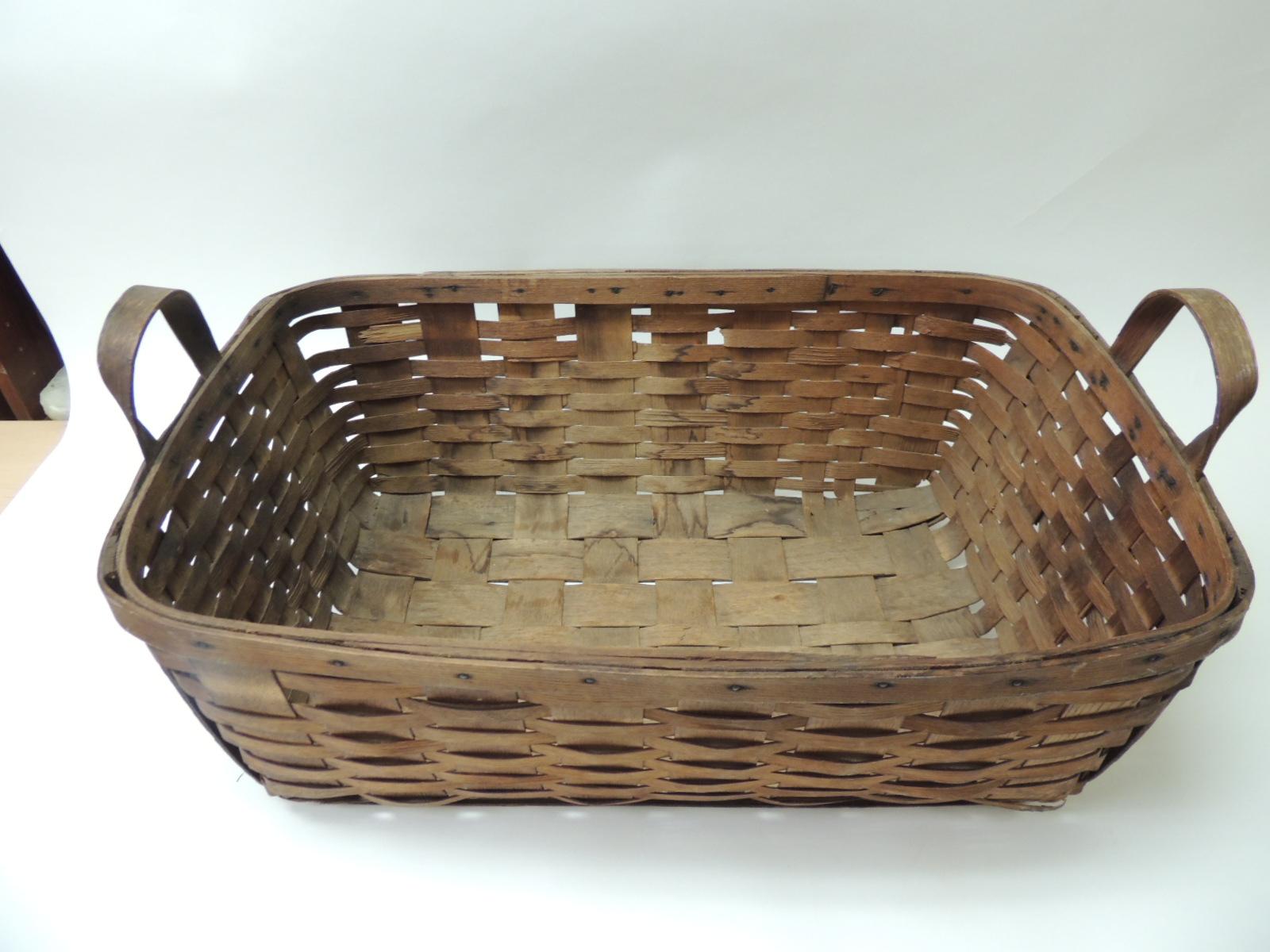 Antique large over-size wooden flat-woven harvest basket with same wood handles
a beautiful patina on the wooden flat woven due to the natural aging process.
USA, 1920s.
Size: 16 x 26 x 9 H.