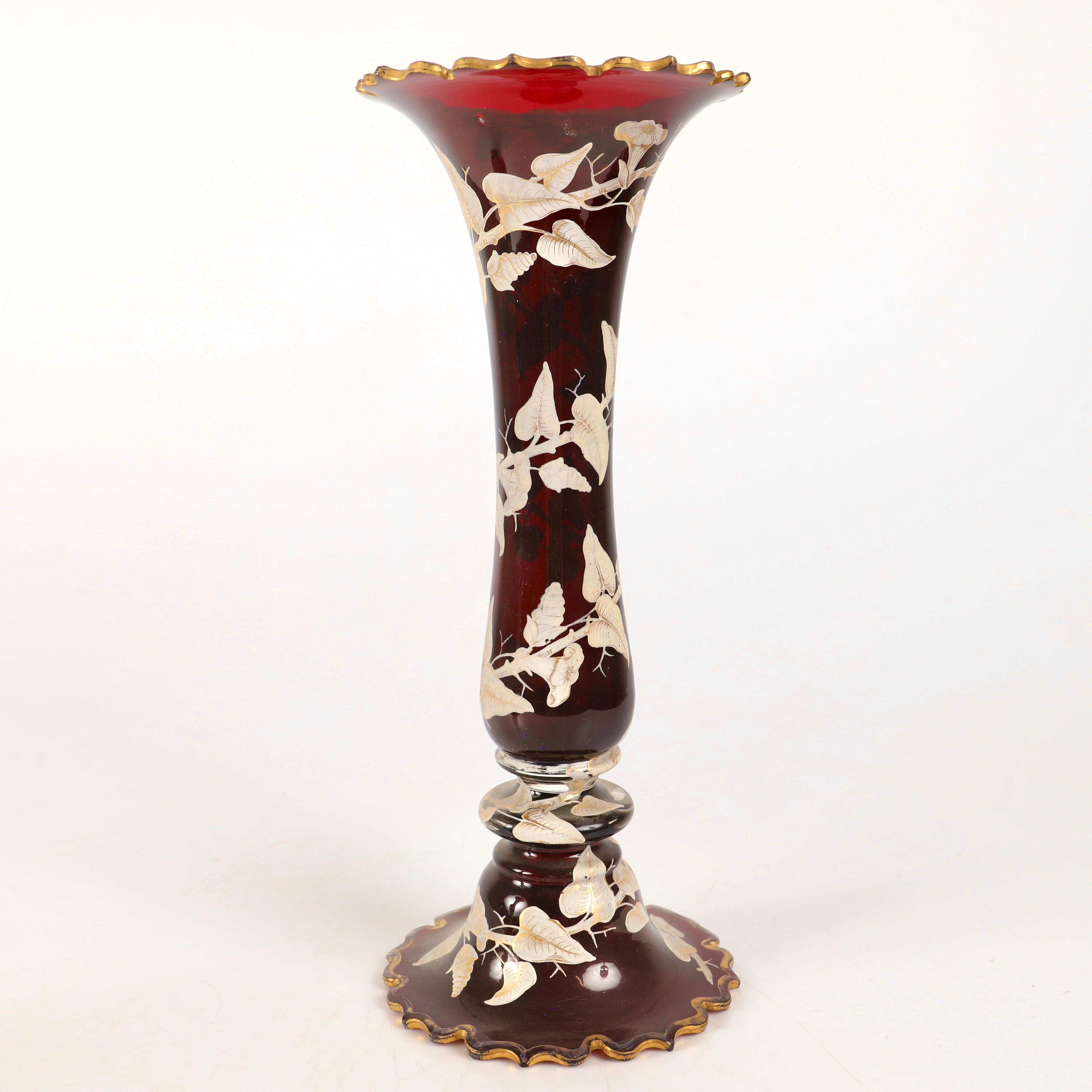 Large ruby-red glass vases

Circular body, hand-painted all around with gilded enamel and 24k matte and burnished gold decoration forming a continuous line of vines from top to bottom

Further gilding highlights on the beautifully cut