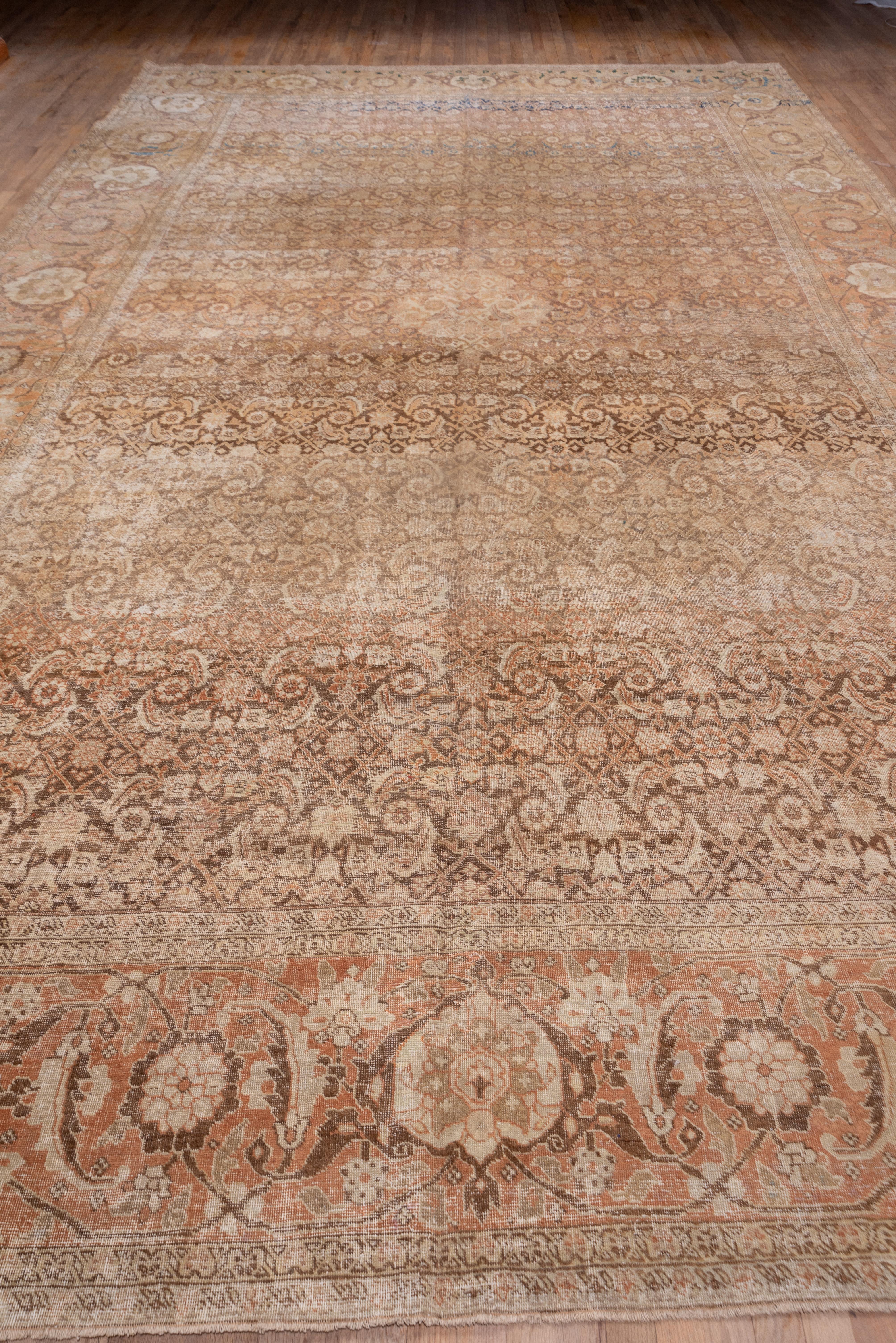 The well-abrashed brown field displays a close all-over Herati pattern in straw and cream, and NW Persian city carpet features a wide buff to rust main border with a bold turtle palmette design accented in brick.