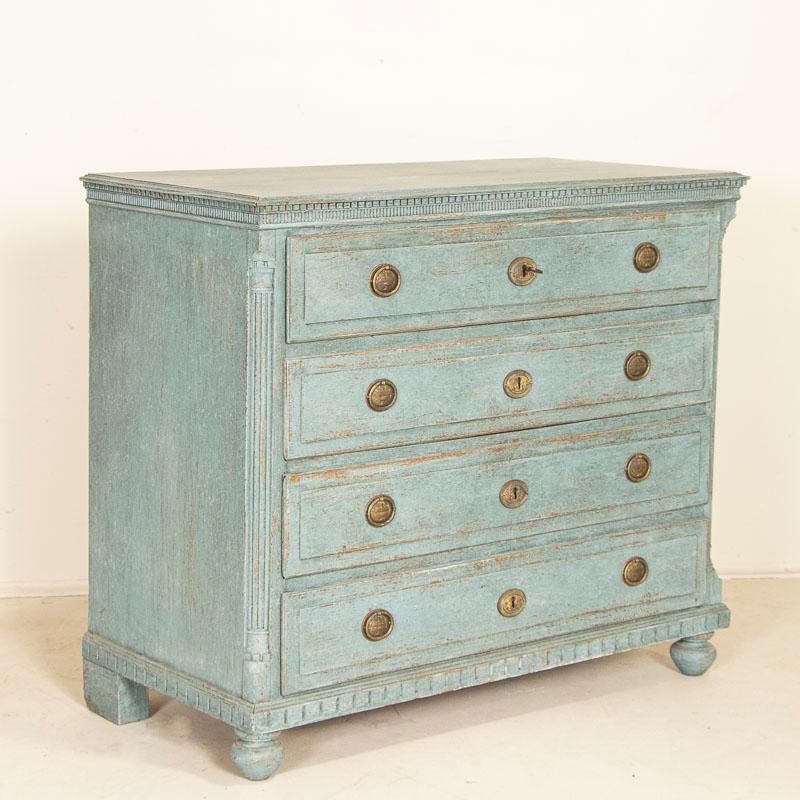 It is the striking blue painted finish that draws one to this handsome large pine chest of drawers. Later professionally painted in blue shades, the  finish has been lightly scraped and sanded exposing the natural wood beneath and beautifully