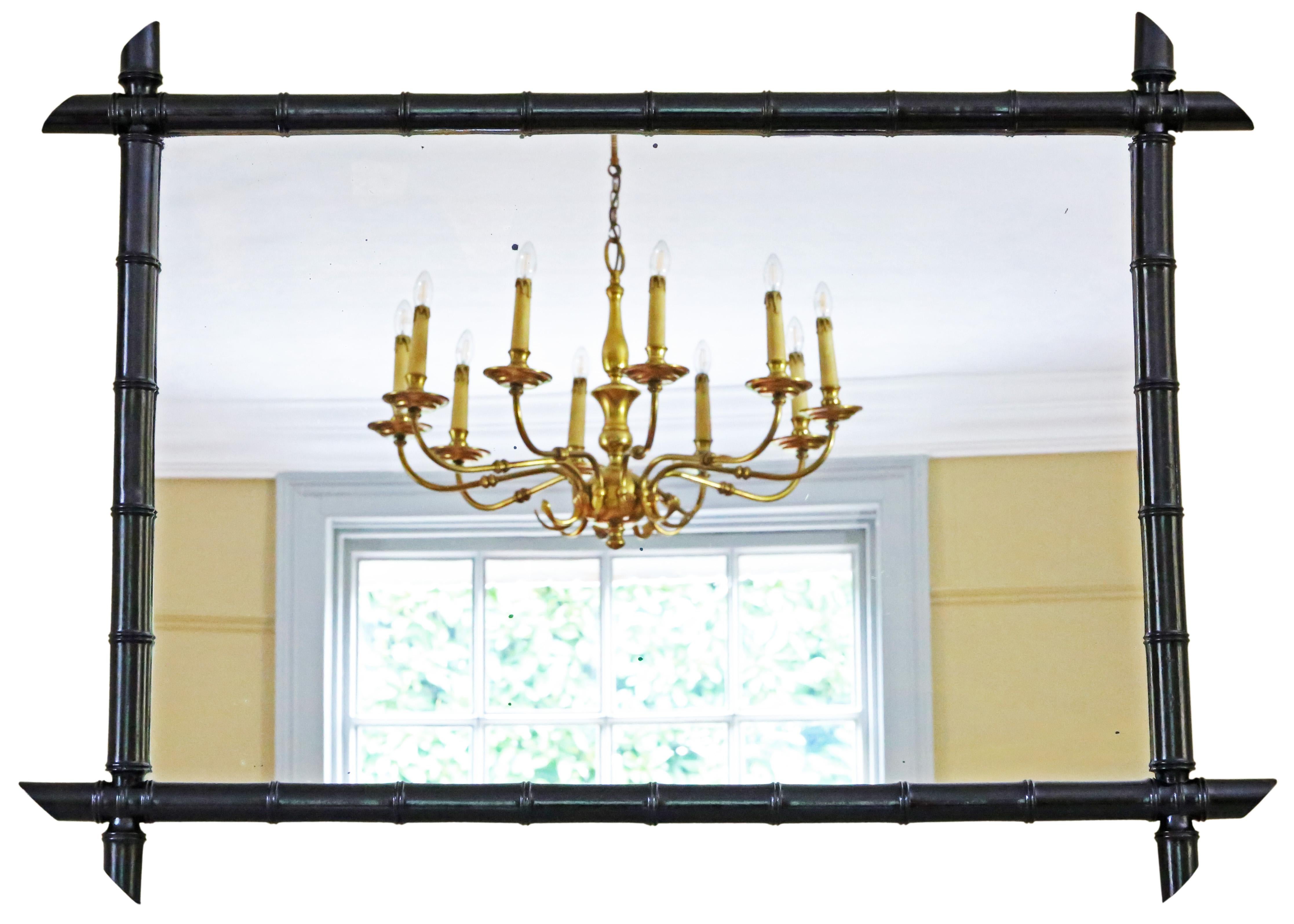 Splendid large ebonised faux bamboo overmantle wall mirror from the 19th Century, boasting fine craftsmanship, charm, and elegance.

This uncommon and enchanting mirror stands out as a noteworthy decorative find, offering an impressive piece that