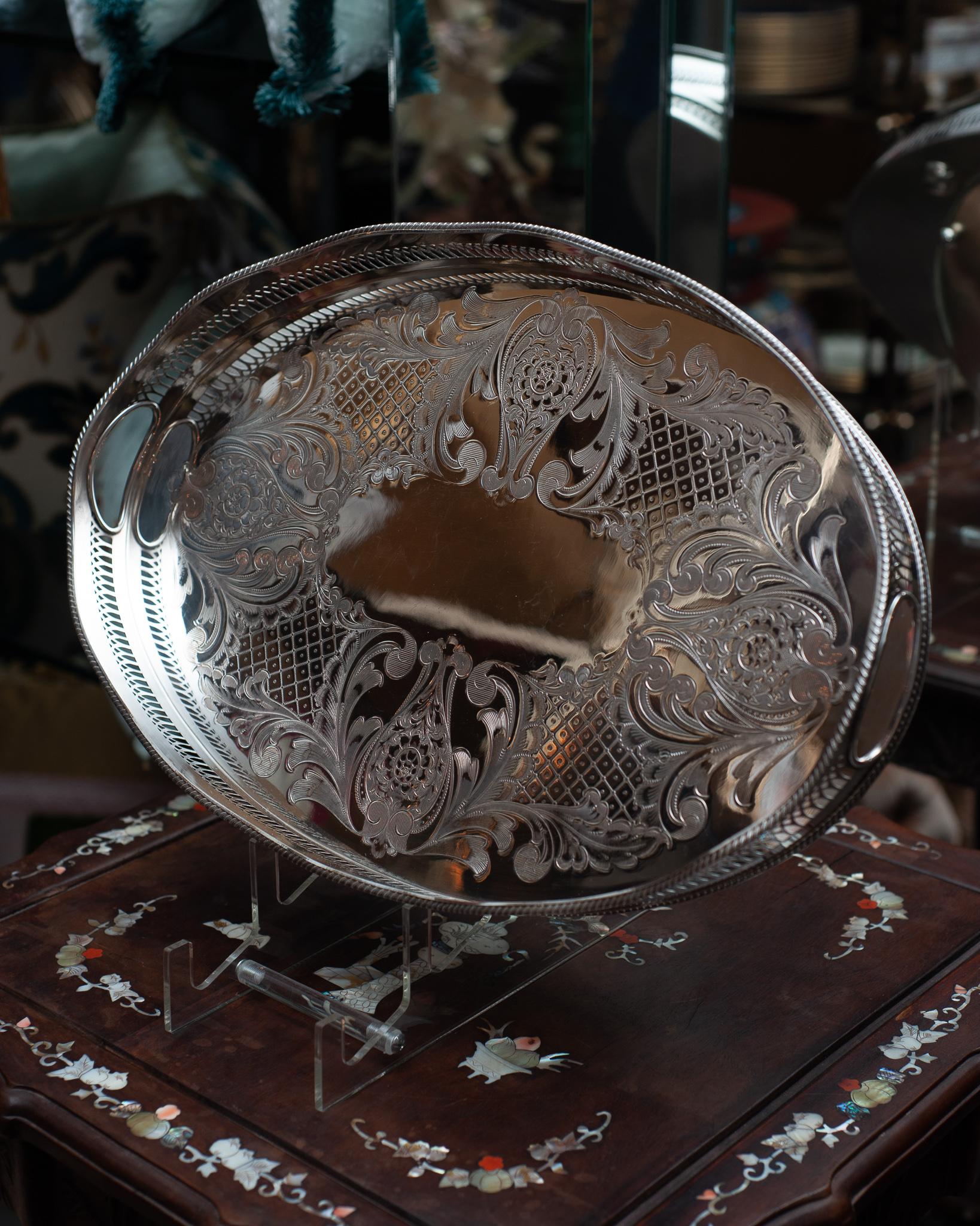 An antique large silver plate oval serving tray with gallery rim and rope boarder.