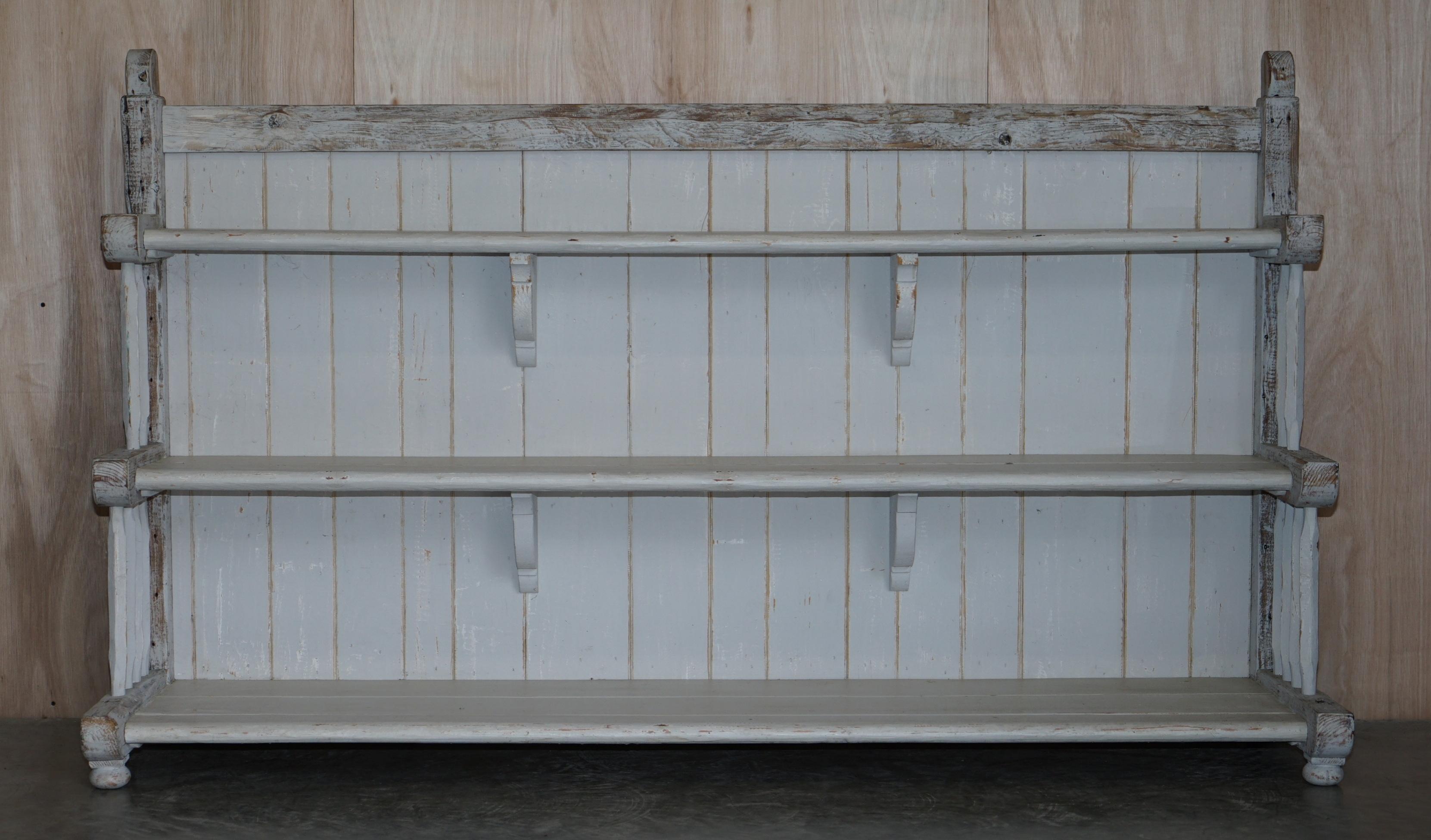 We are delighted to offer for sale this very large Antique circa 1900 waterfall bookshelf with original distressed period paint

A very good looking well made and decorative piece, this is the largest of its type I have ever seen, at over 2 meters