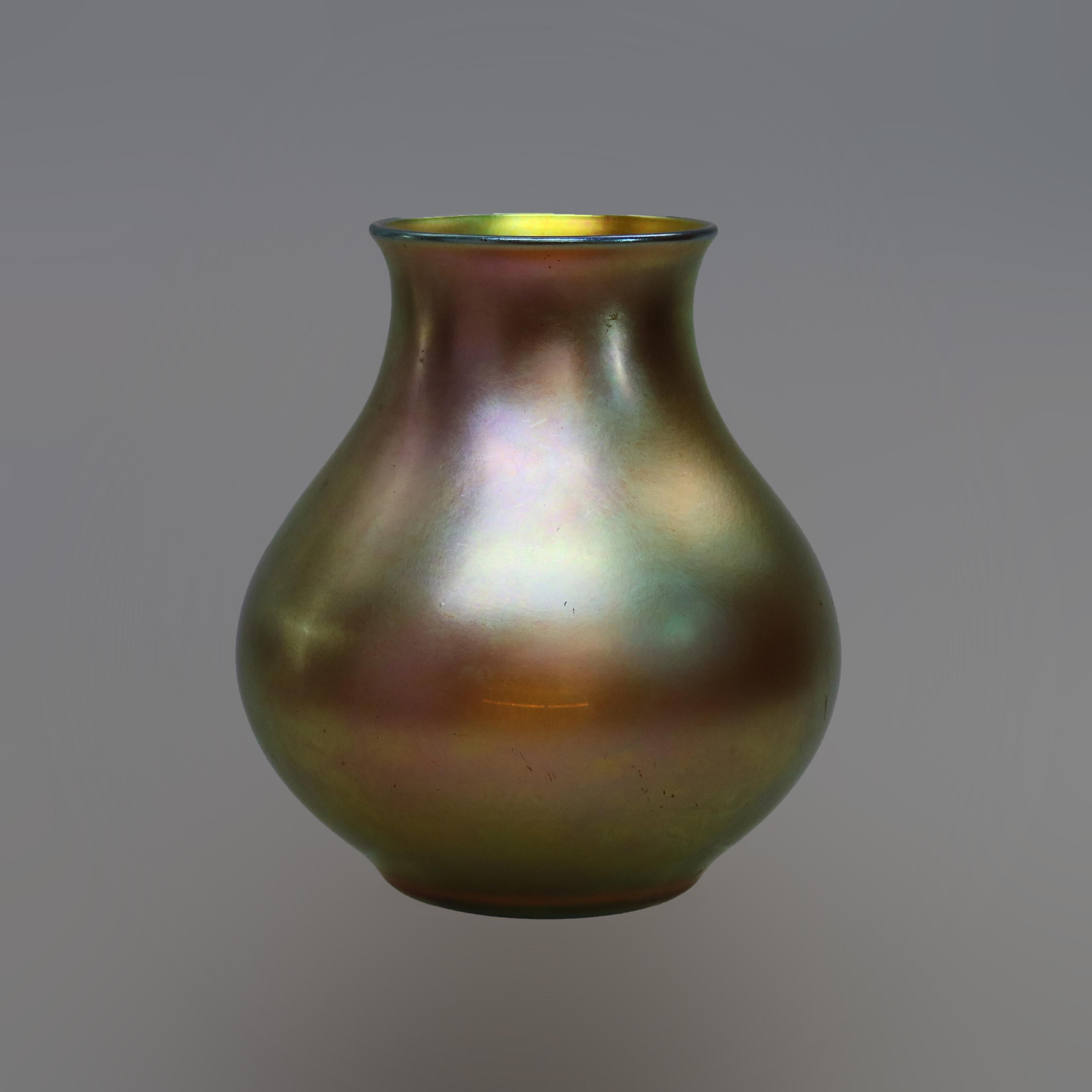An antique and large Arts and Crafts vase by Steuben offers Gold Aurene art glass in bulbous form, signed on base as photographed, c1920.

Measures: 9.5