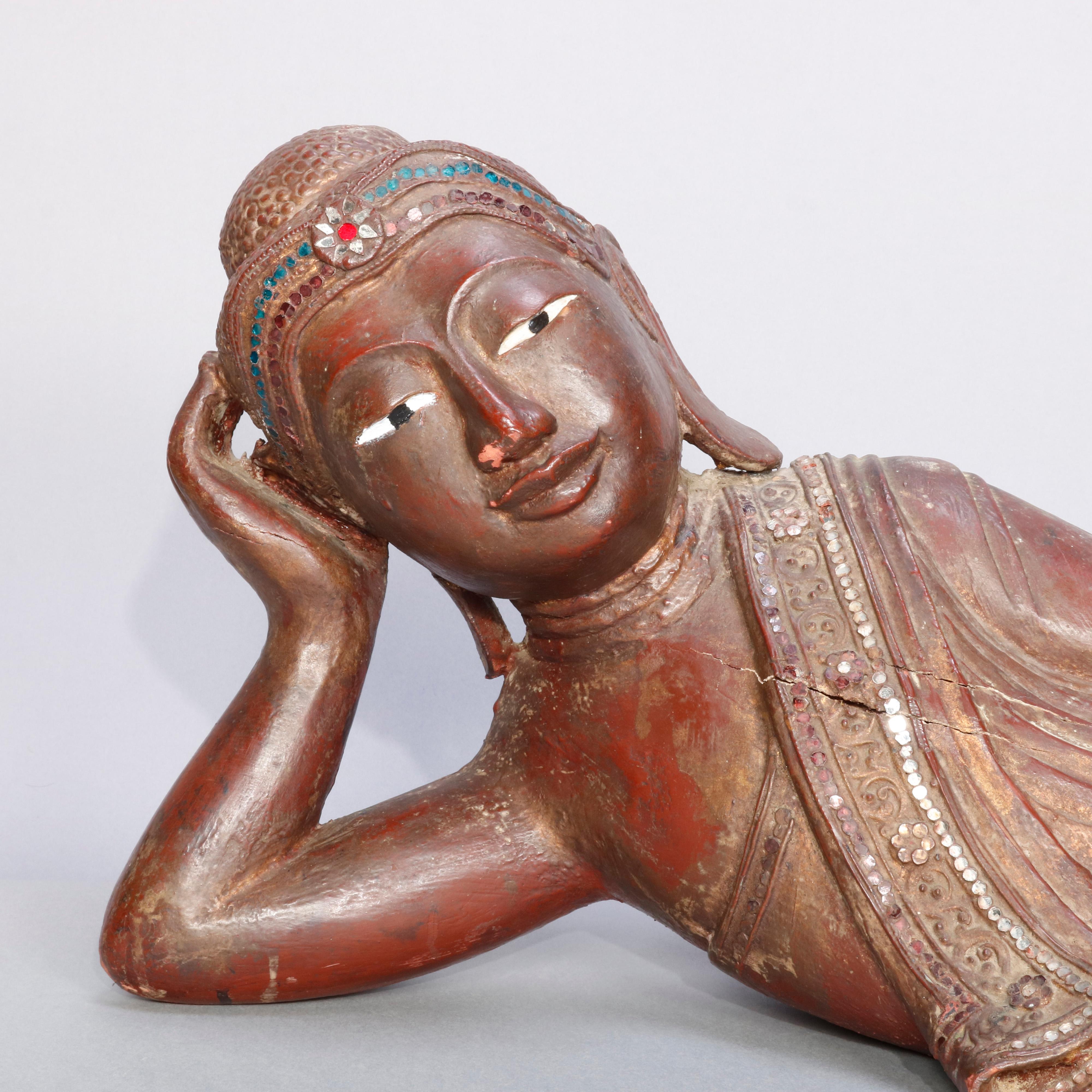 An antique and large Tibetan 19th century carved wood recumbent Manjushri Buddha features jeweled red wash vermilion finish with mother of pearl inlay, circa 1860.

Measures: 11