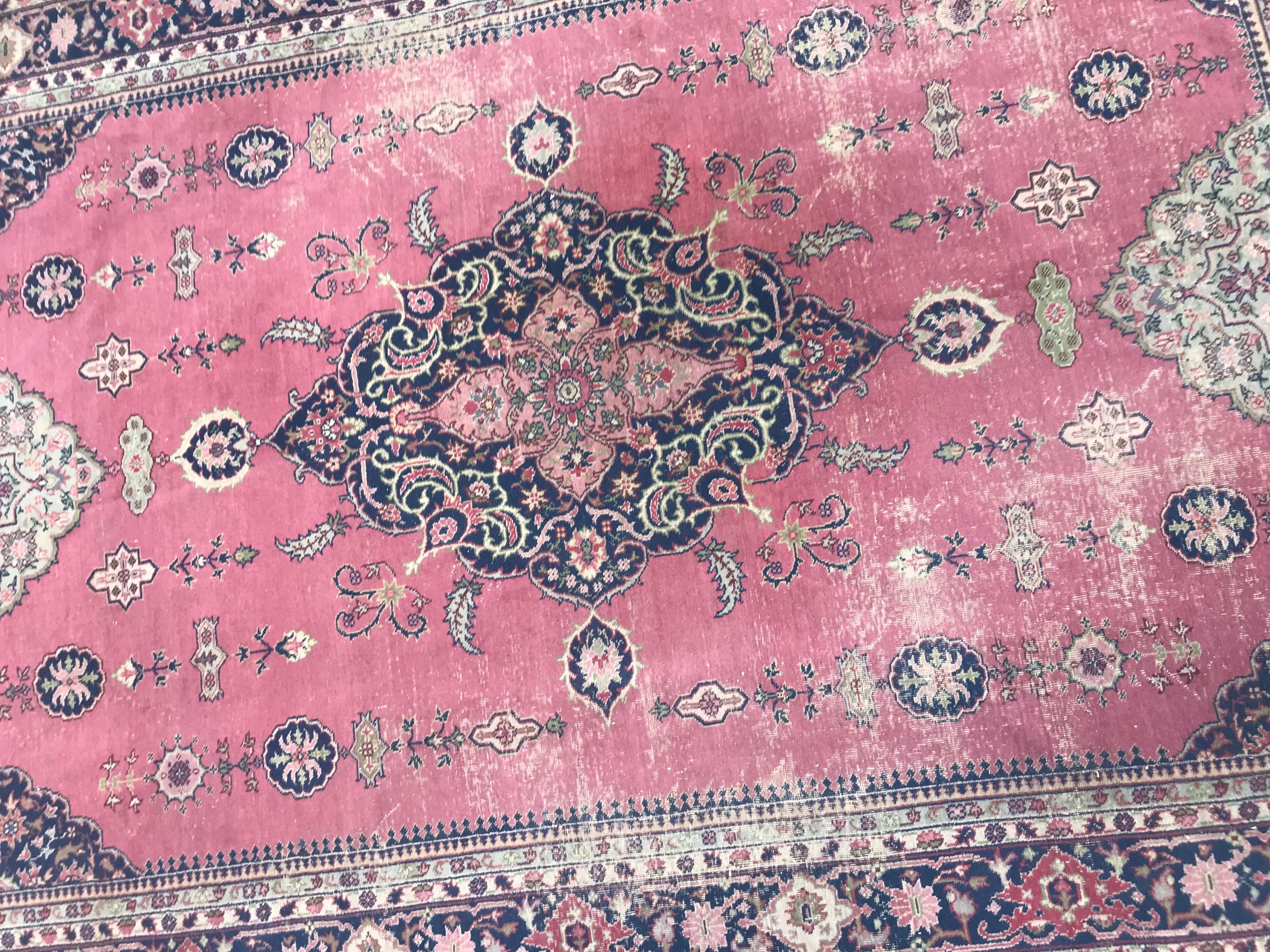 Nice early 20th century large Turkish rug from Sparta, with a central medallion design and beautiful pink field color, blue purple and green, entirely hand knotted with wool velvet on cotton foundation.