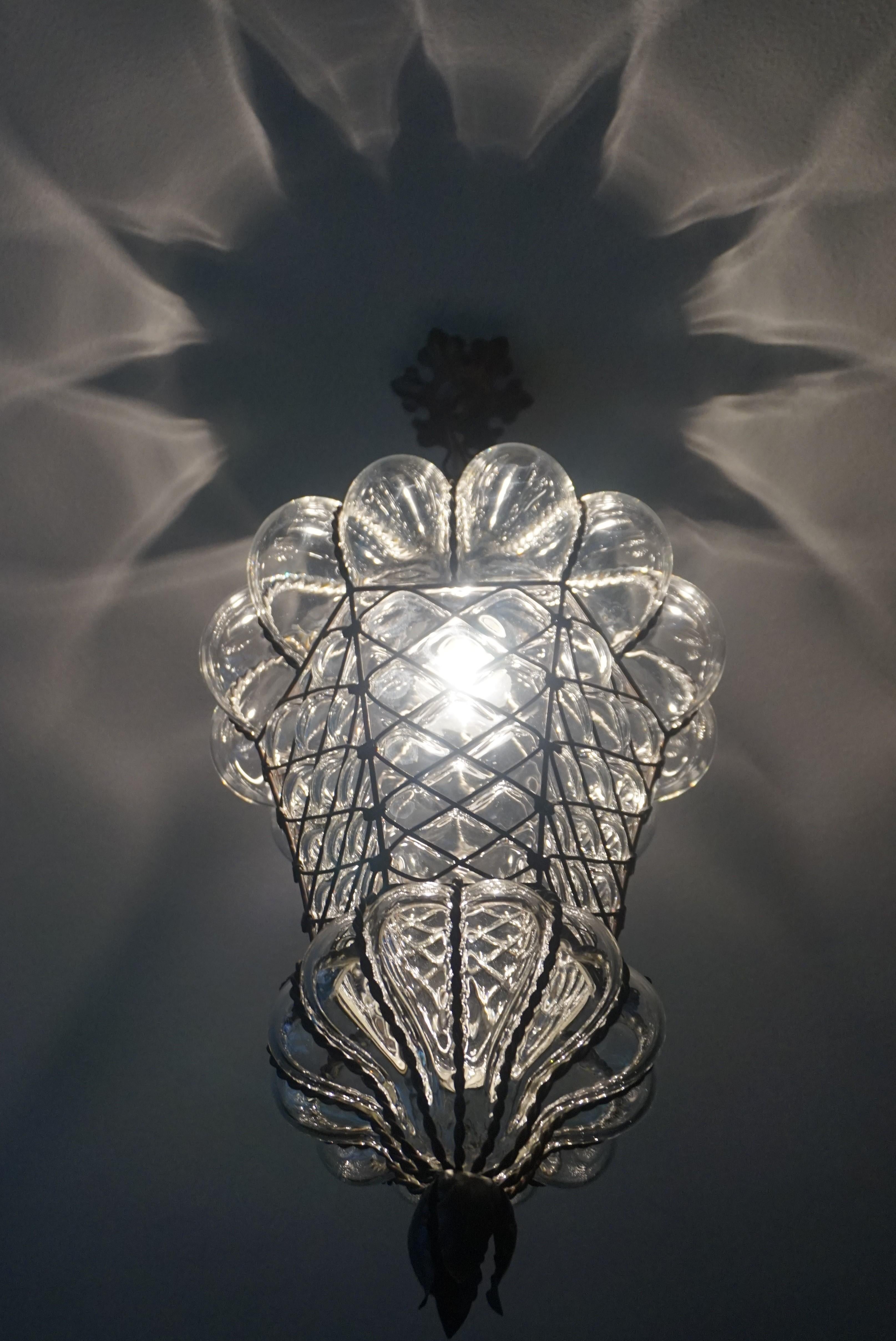 Victorian era, transparent glass and superb condition Venetian light fixture.

This antique Venetian pendant is not only the largest of it's kind we ever had the pleasure of offering, it also is in exceptional condition. We have completely rewired