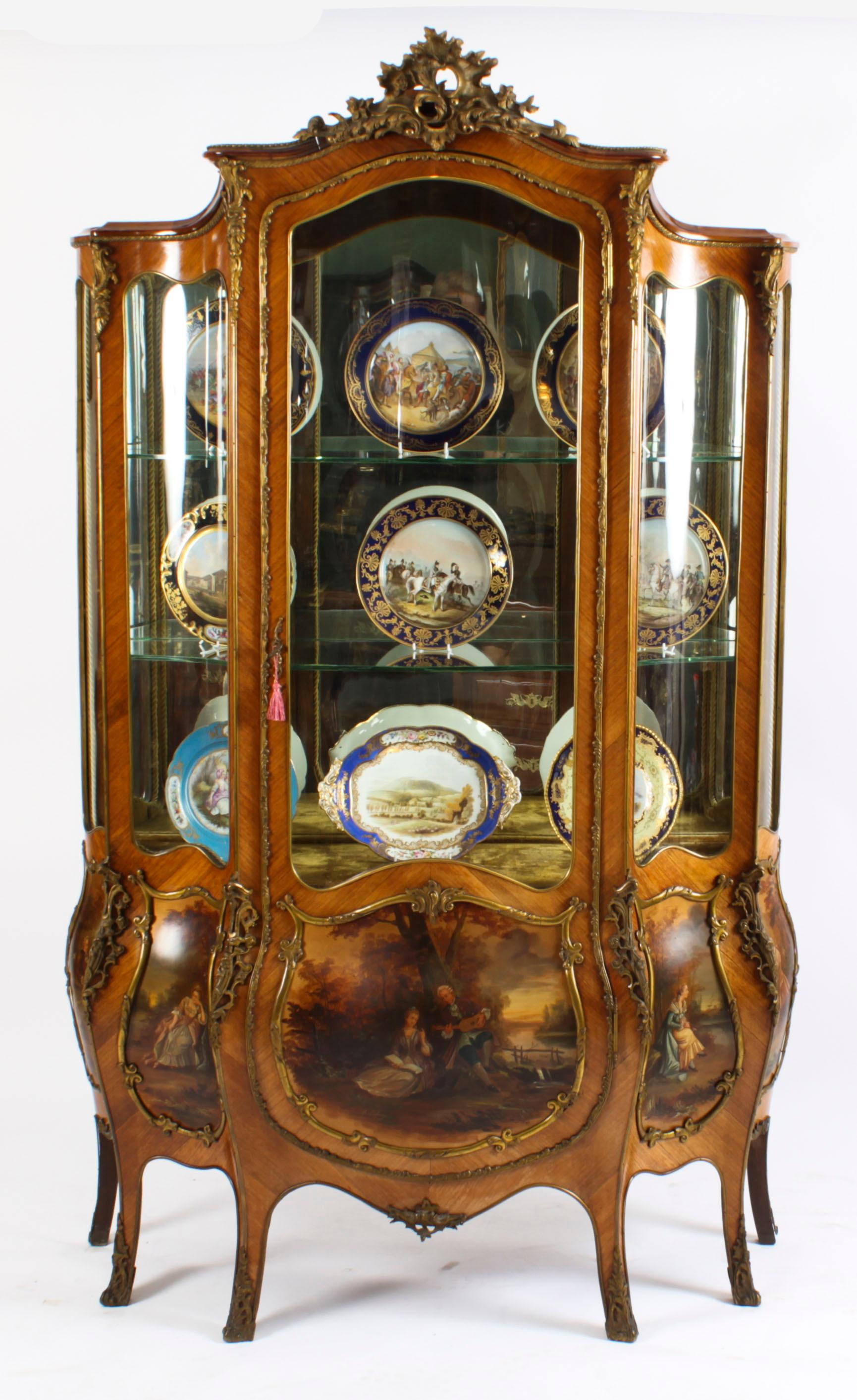 A stunning large antique French wood Vernis Martin five panel display cabinet in the Louis XV manner and of extravagantly shaped Bombe form, circa 1870 in date, with exquisite hand painted decoration and exquisite ormolu mounts.
 
It has five