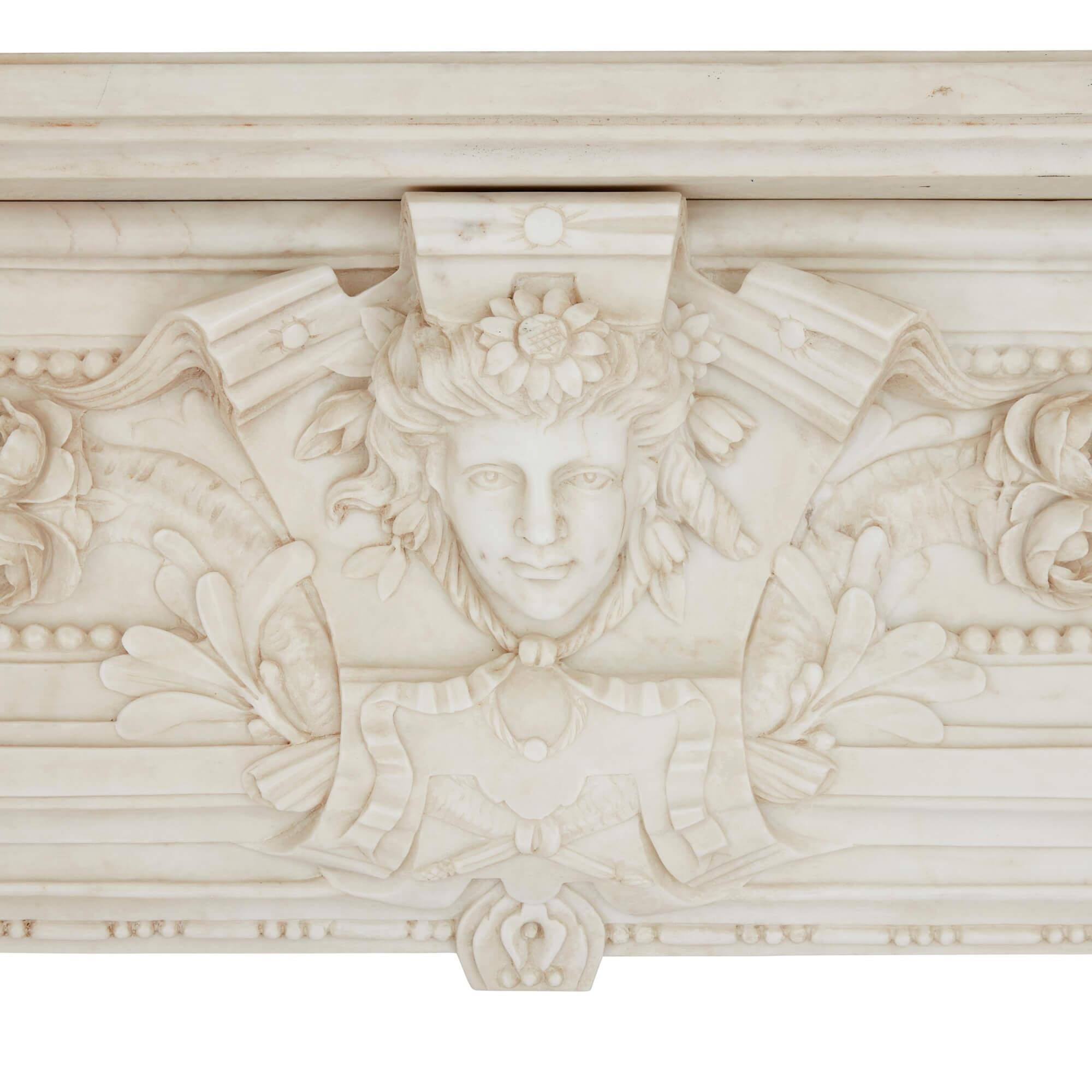 Antique large white marble fireplace, French 19th century
French, 19th Century
Height 140cm, width 185cm, depth 51cm

This incredible piece of marble furniture is superbly carved in the Louis XVI style. The apron is centred with a high-relief mask: