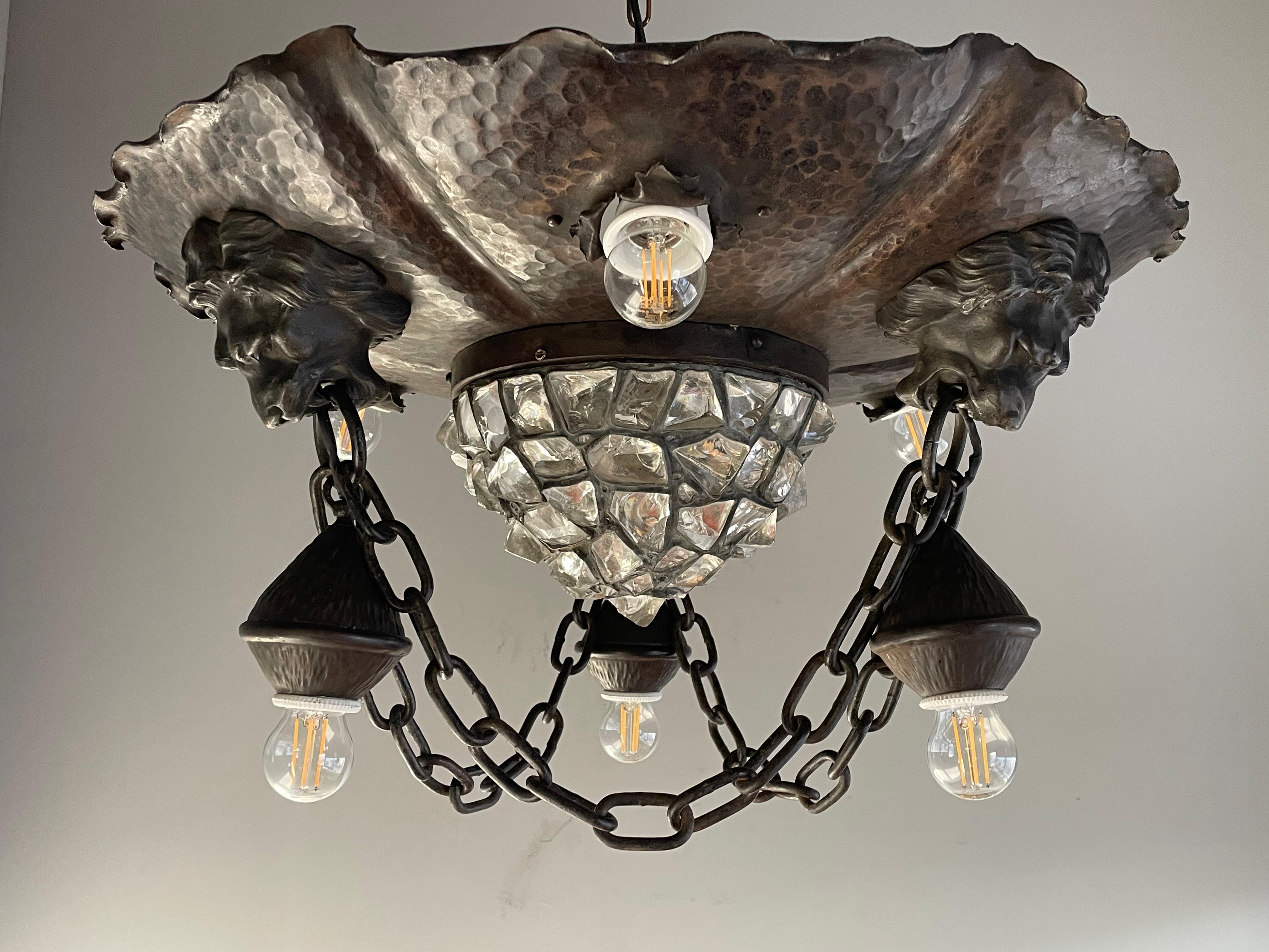 Bronzed wrought iron and chunky glass shade, work-of-art light fixture from 1910s.

This one of a kind and artistic workmanship flush mount from the earliest years of the 1900s is another one of our recent great finds. With early 1900s lighting
