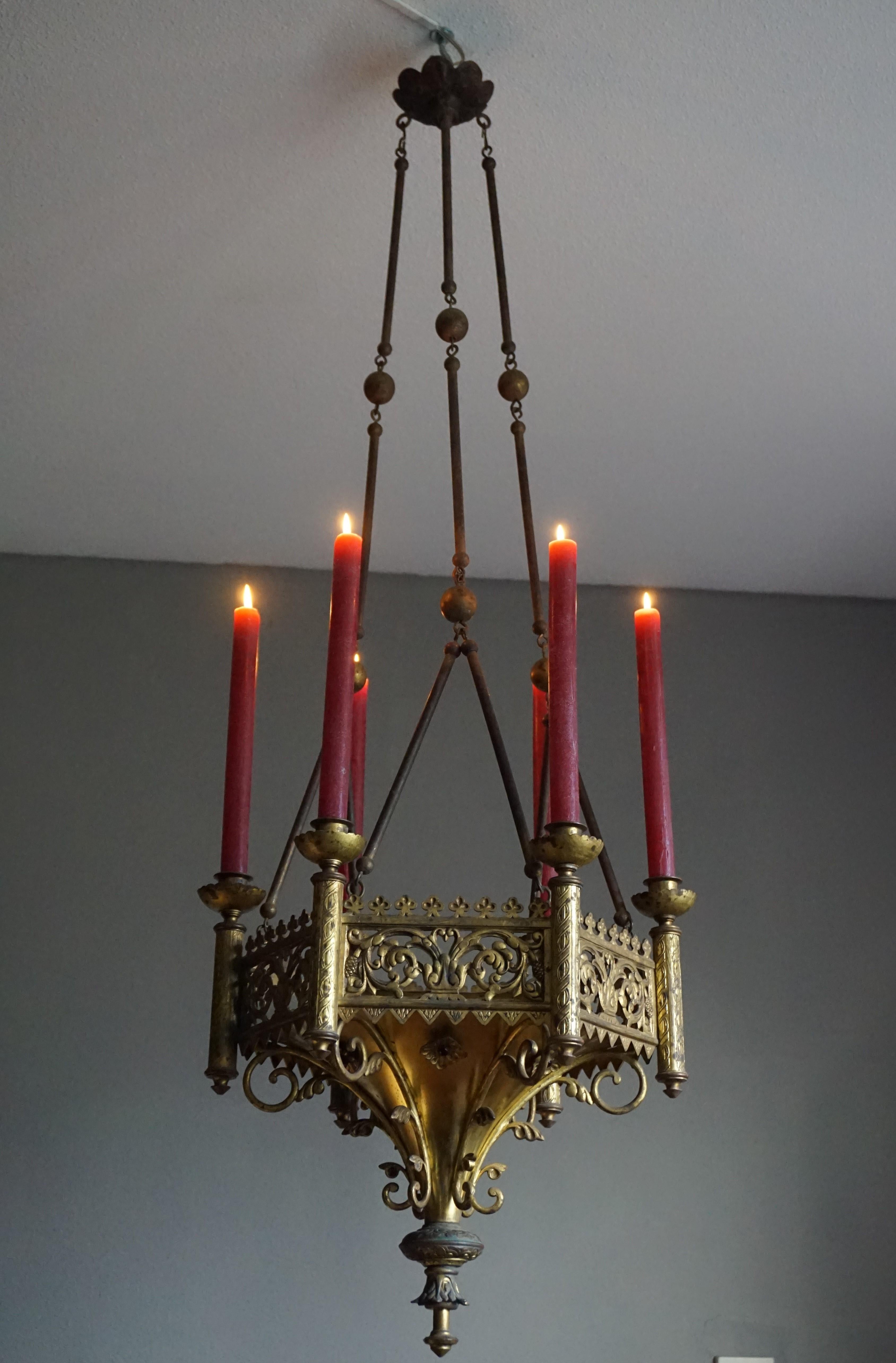 Good size and all handcrafted antique bronze chandelier with brass chains.

Finding good quality and great looking Gothic antiques in their original condition always lifts our spirits. This Gothic candle chandelier too fits that bill and its good