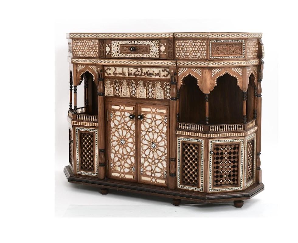 Elevate your living space with this Antique Moroccan-Style Handmade 19th-Century Sideboard Cabinet, a masterpiece of Moorish craftsmanship that exudes exotic beauty and intricate detailing. This exquisitely detailed cabinet, with its stunning inlaid