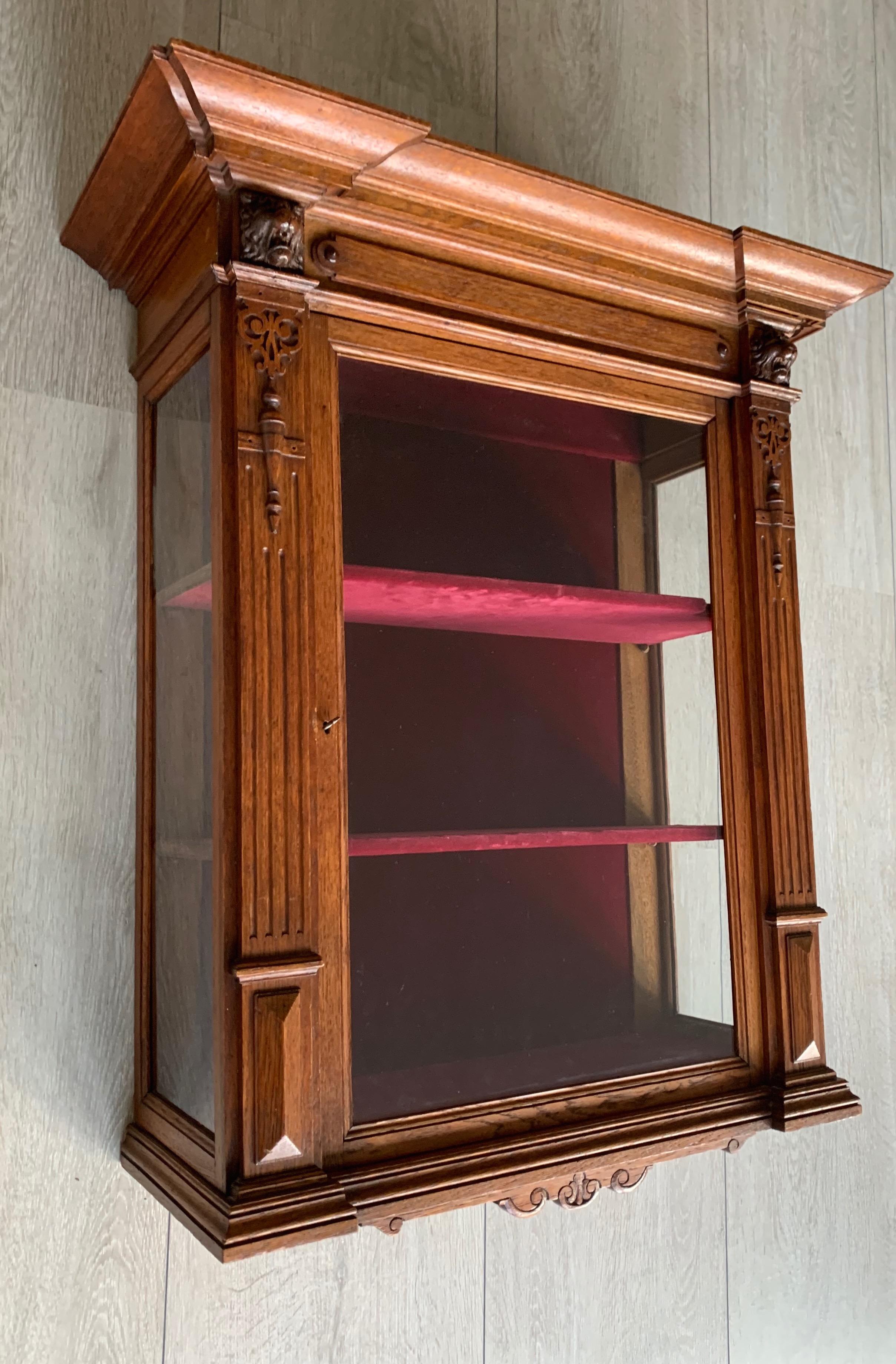 Beautifully handcrafted cabinet with a red velvet interior.

This finest quality 19th century, single door wall cabinet with its original glass panel is a work of art in its own right and it is in excellent condition. This good sized antique is