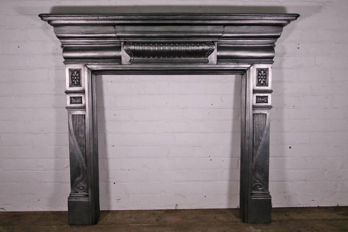 Antique late 19th century cast iron fireplace surround, dated 1895. 

We currently have a pair of these surrounds available. Slight size difference between the two. 

This surround has been finished with traditional black grate polish, leaving a