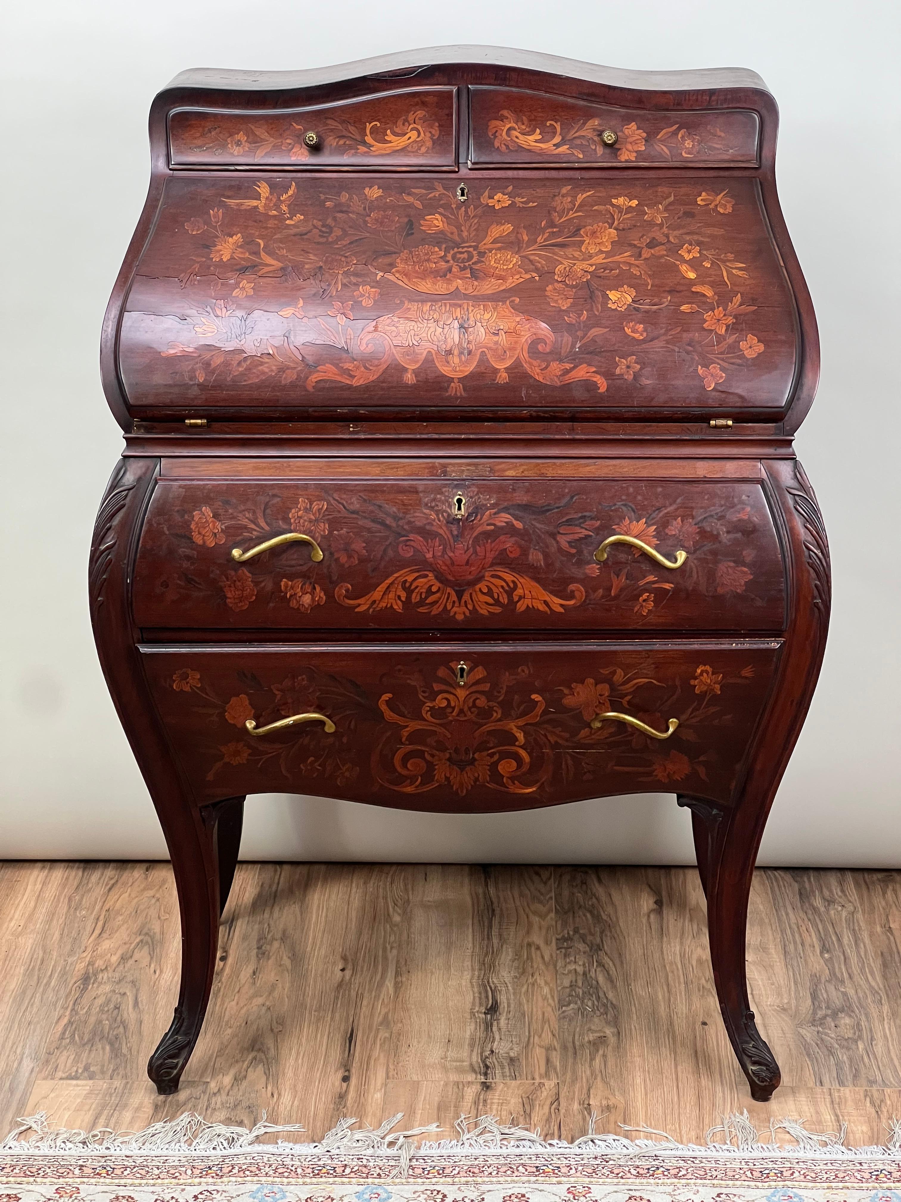 This late 19th-century Dutch marquetry ladies writing desk is a splendid example of the ornate craftsmanship that defines the period. Adorned with meticulously detailed floral inlays, the desk showcases a variety of wood hues intricately pieced