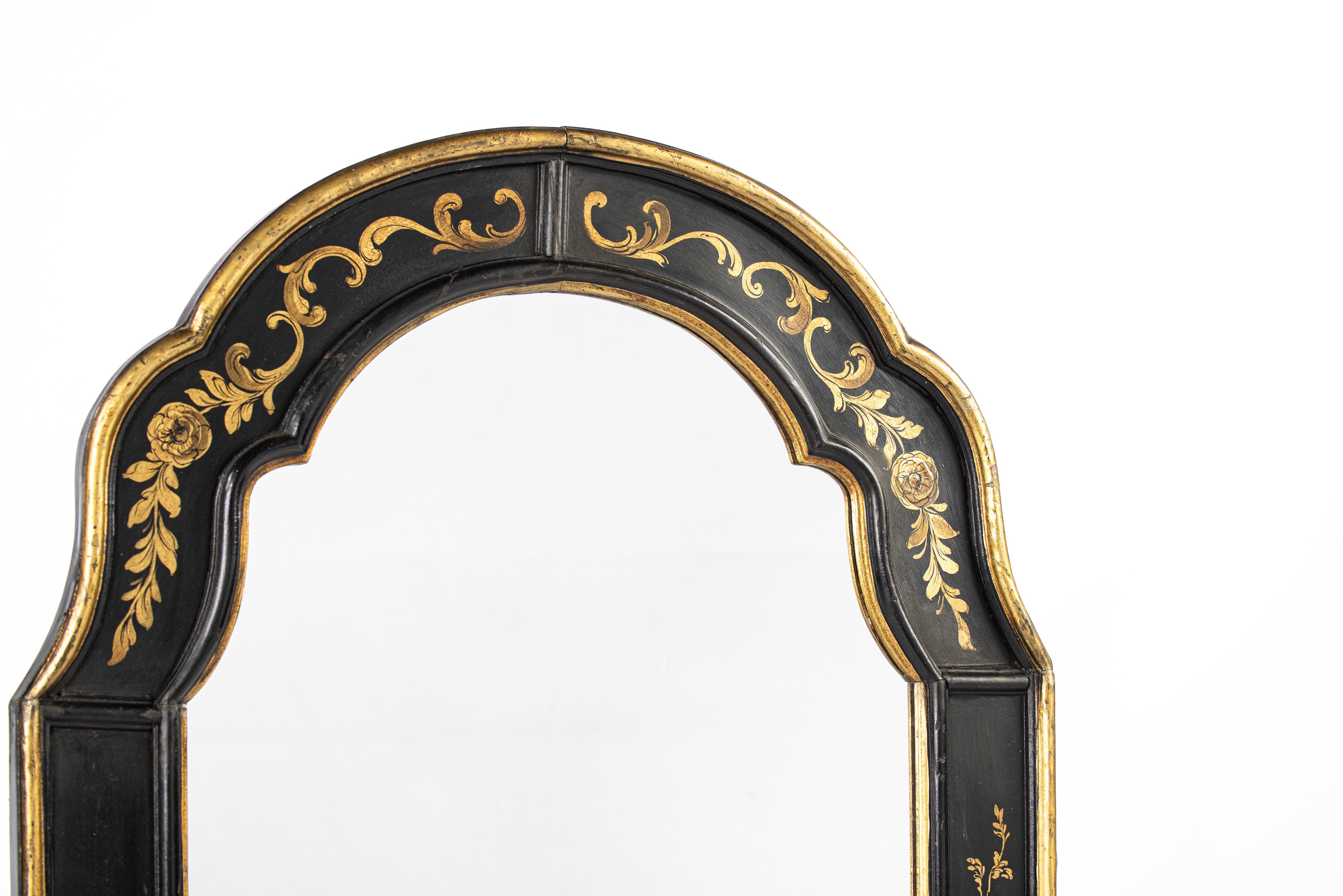 This beautiful antique mirror was made in central France at the end of the 19th century, around 1890. The mirror features a convex-concave-shaped top. The frame is made of pine wood and smoothed with gesso. The frame has a black base color and is